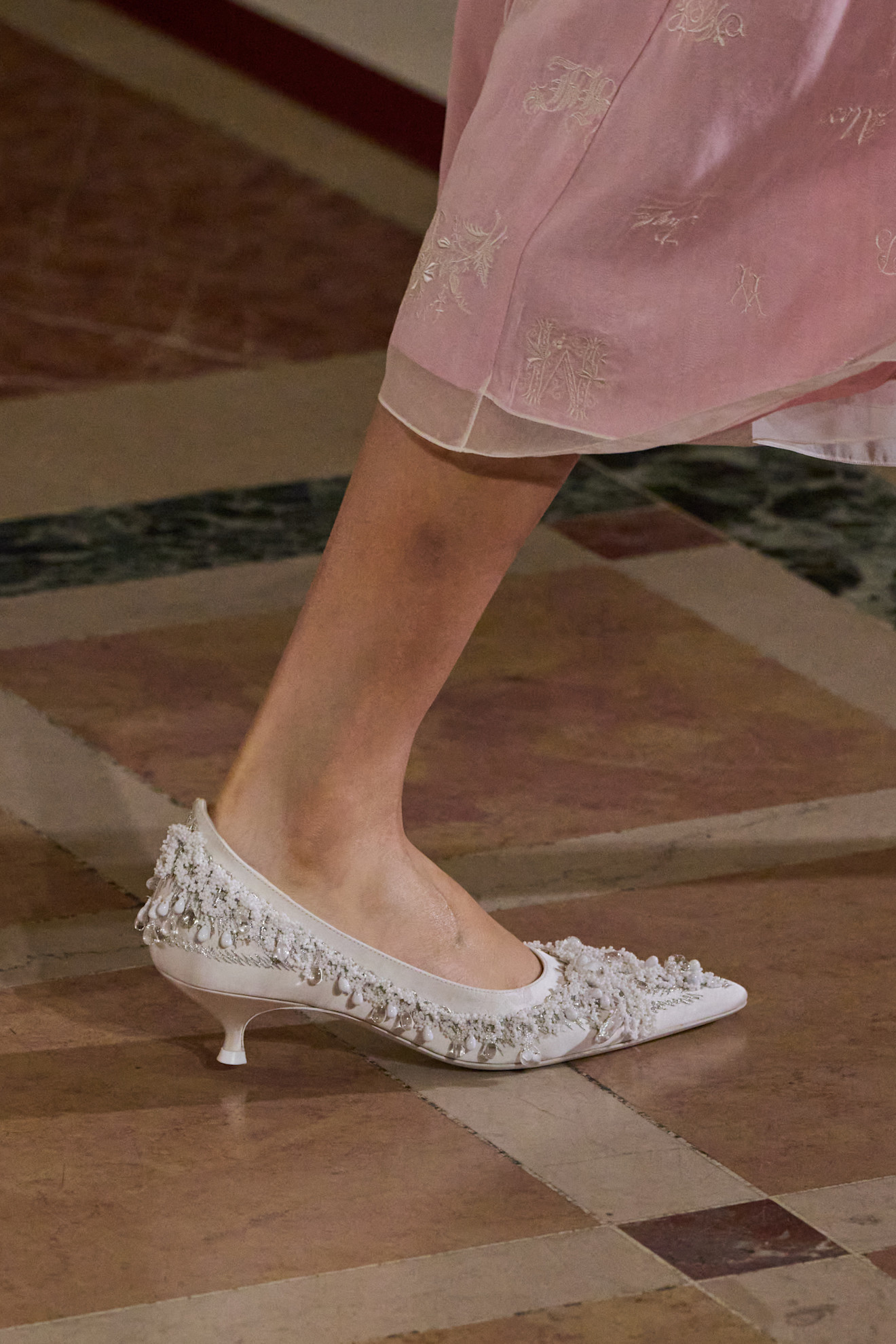 Detail shot of a Tory Burch beaded kitten heel on the runway.