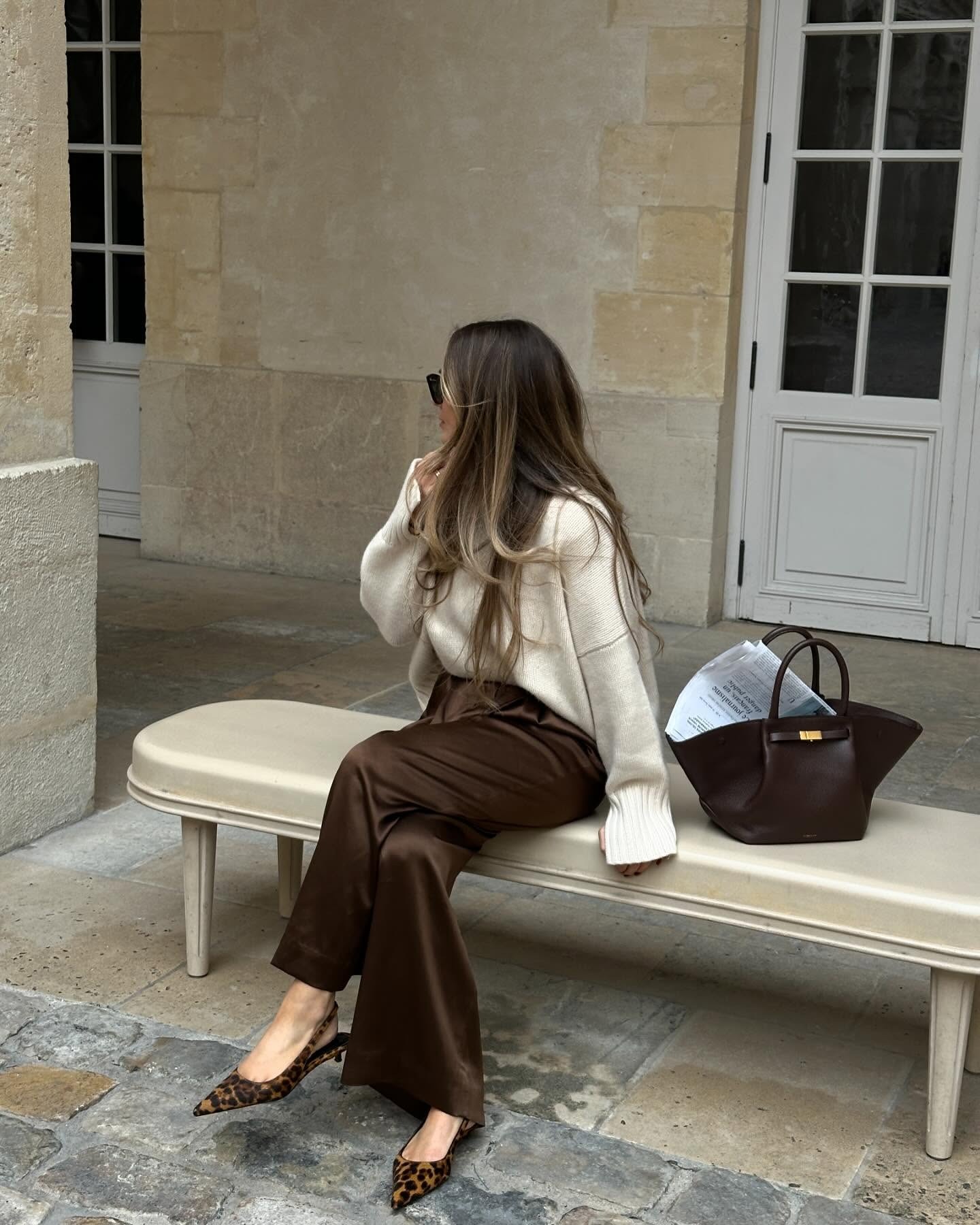 @oliviafaeh in satin pants, a white turtleneck sweater, and leopard print slingback heels.