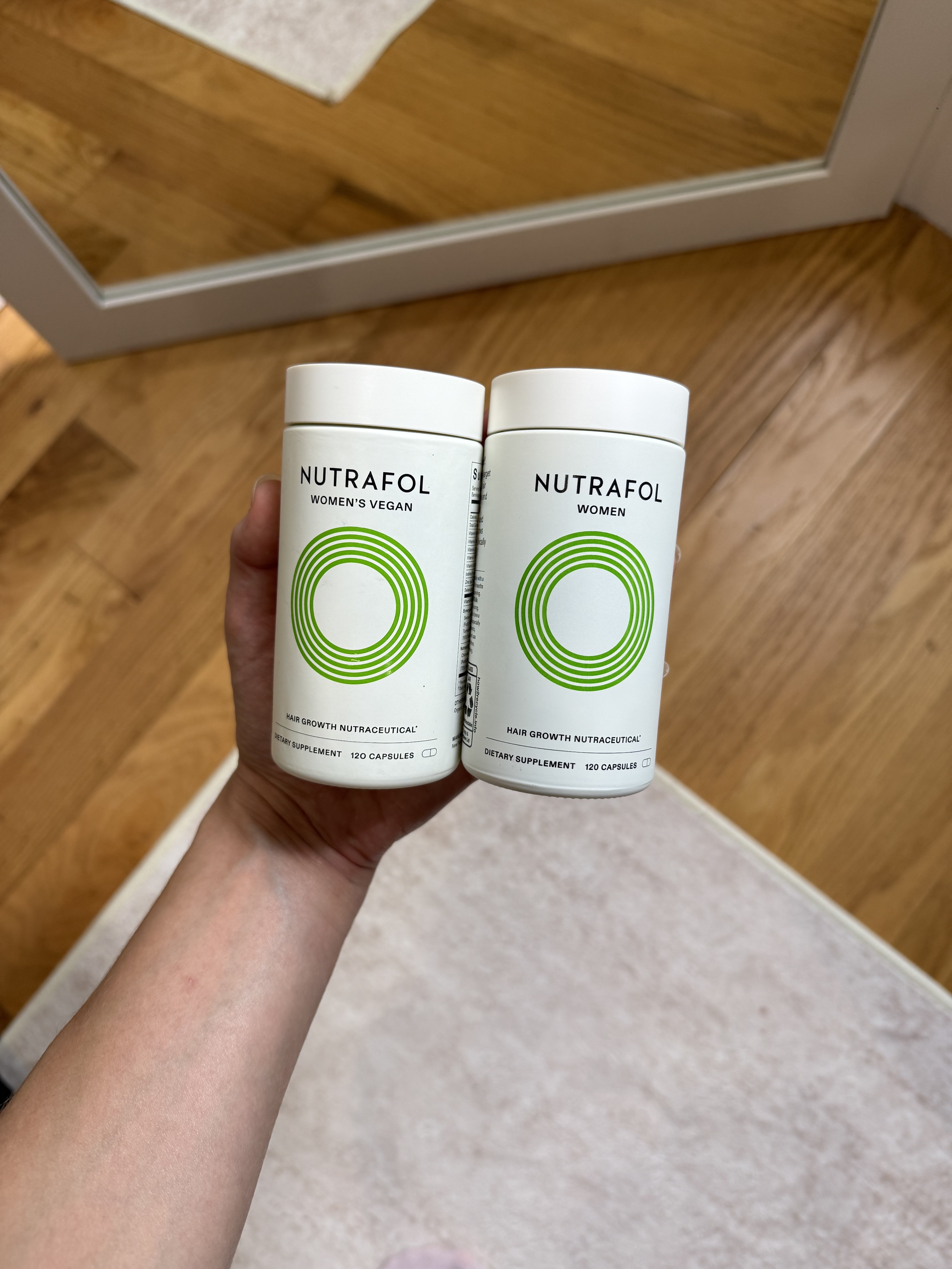 Jamie Chevron holding Nutrafol Women's Vegan and Nutrafol Women.