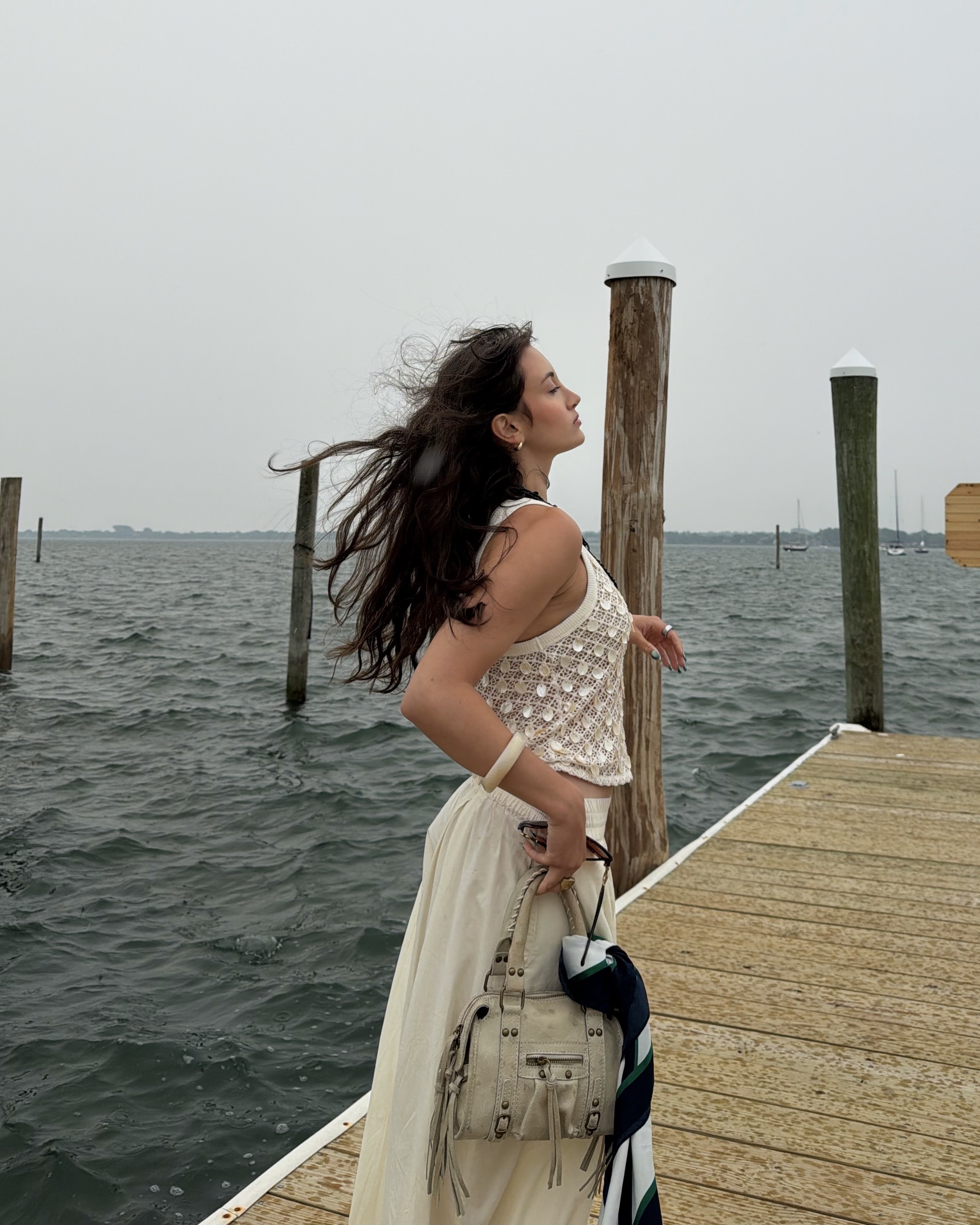 An image of Who What Wear associate beauty editor Alyssa Brascia with wavy hair blowing in the wind.