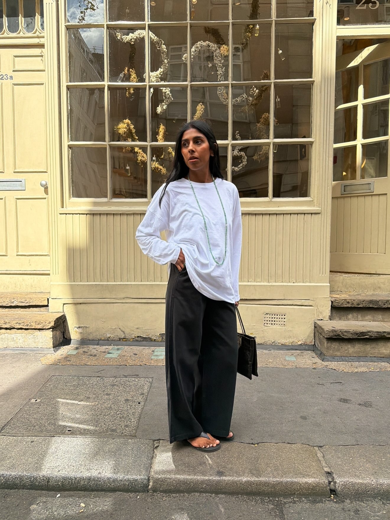 Woman in a white long sleeve tee and black pants.