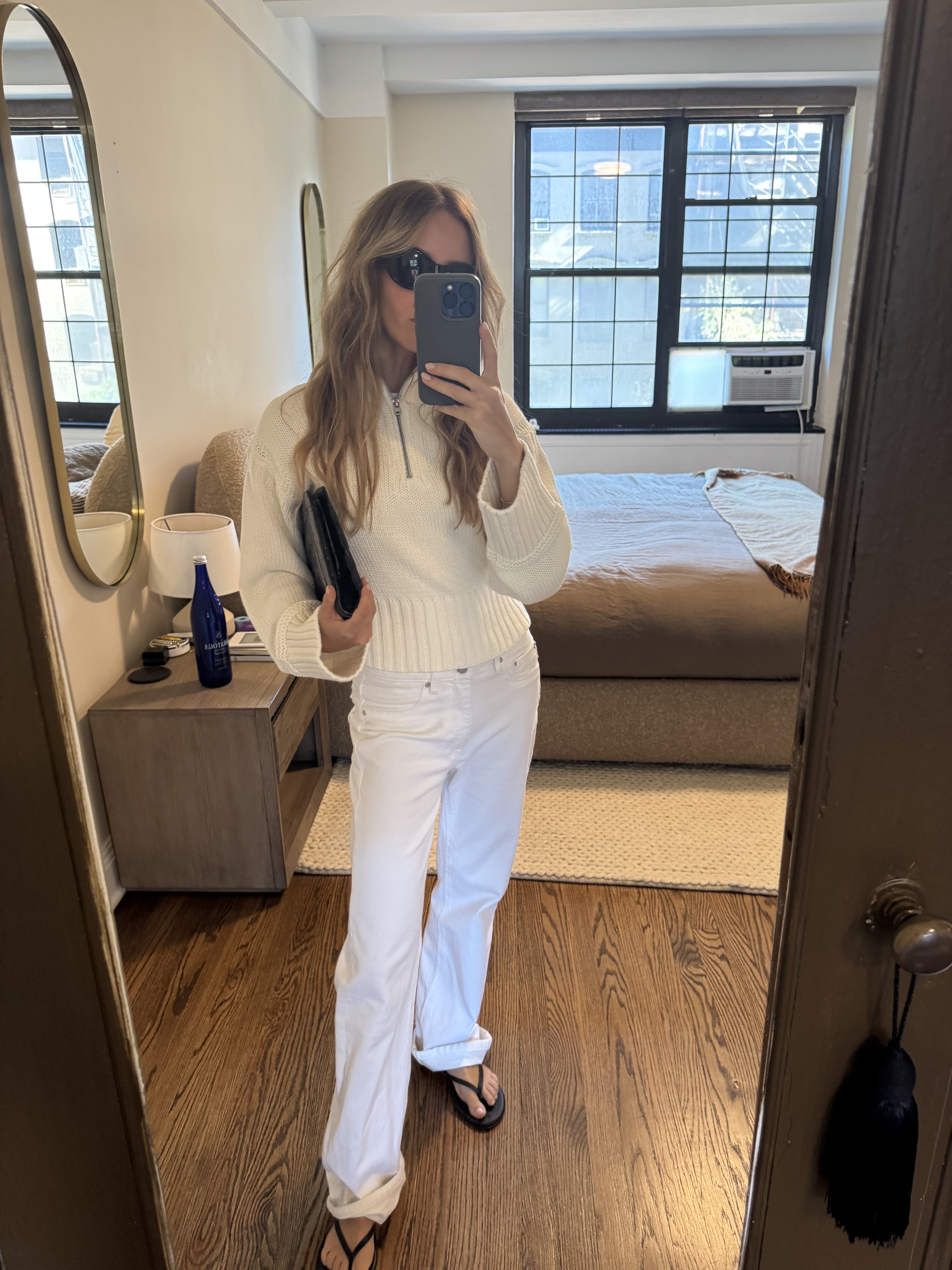 Nikki wears the ivory rollneck with white jeans, black flip-flops and a black clutch.