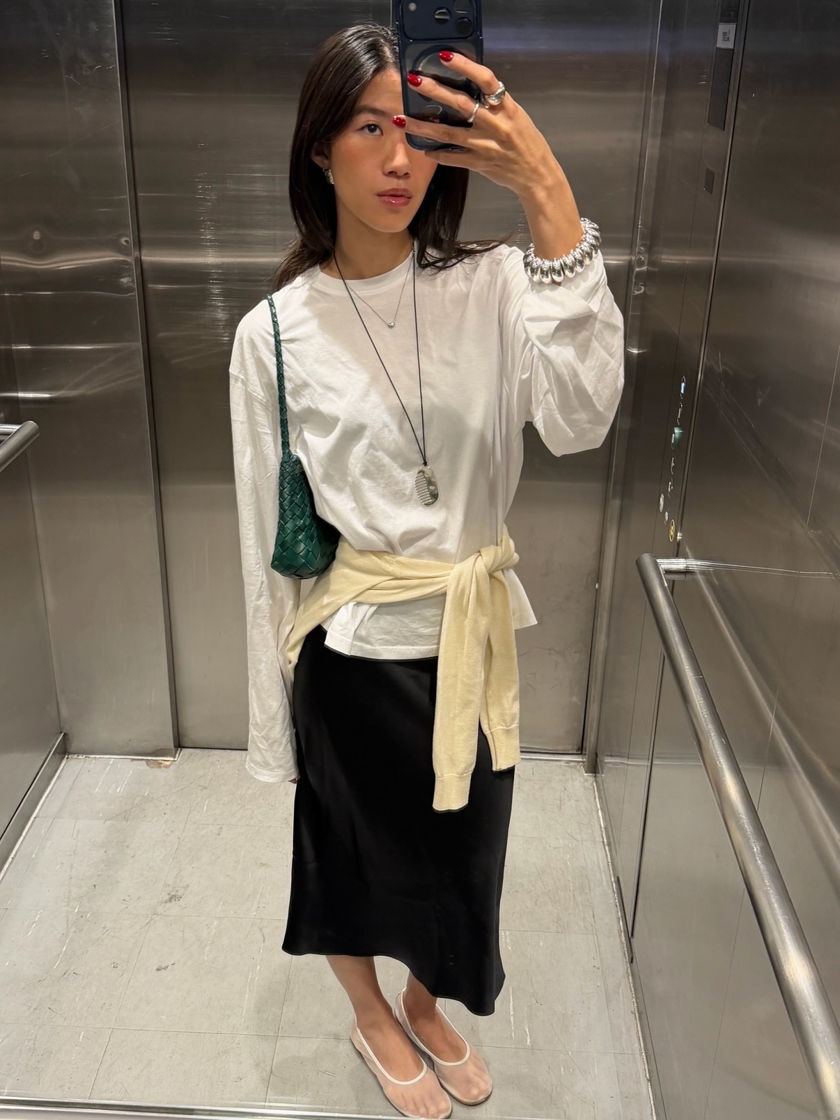 An image of @hidings  wearing mesh shoes with a pencil skirt, white long-sleeved shirt and a yellow jumper tied around her waist.