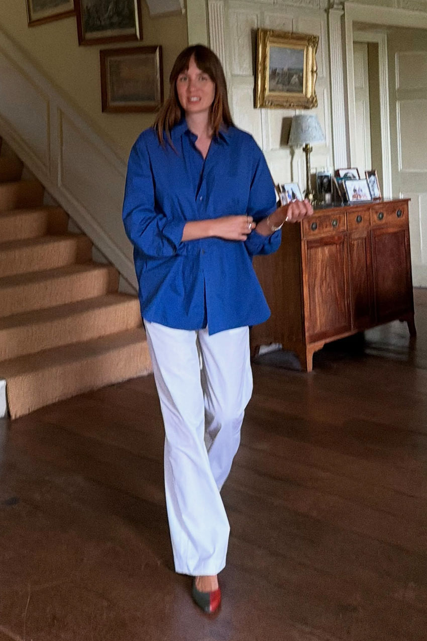 woman wearing a blue button-down shirt, white pants, and two-tone heels