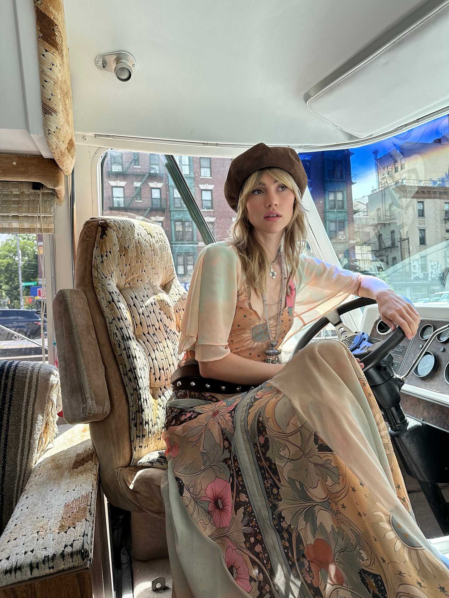 Suki Waterhouse on bus in full boho outfit.