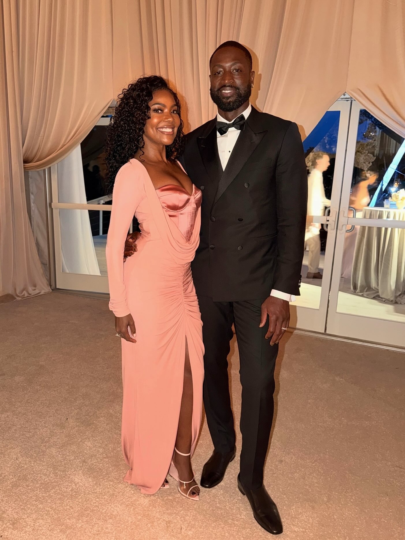 Gabrielle Union wears a long sleeved pink Zuhair Murad fall 2026 dress to Coco Jones's wedding.