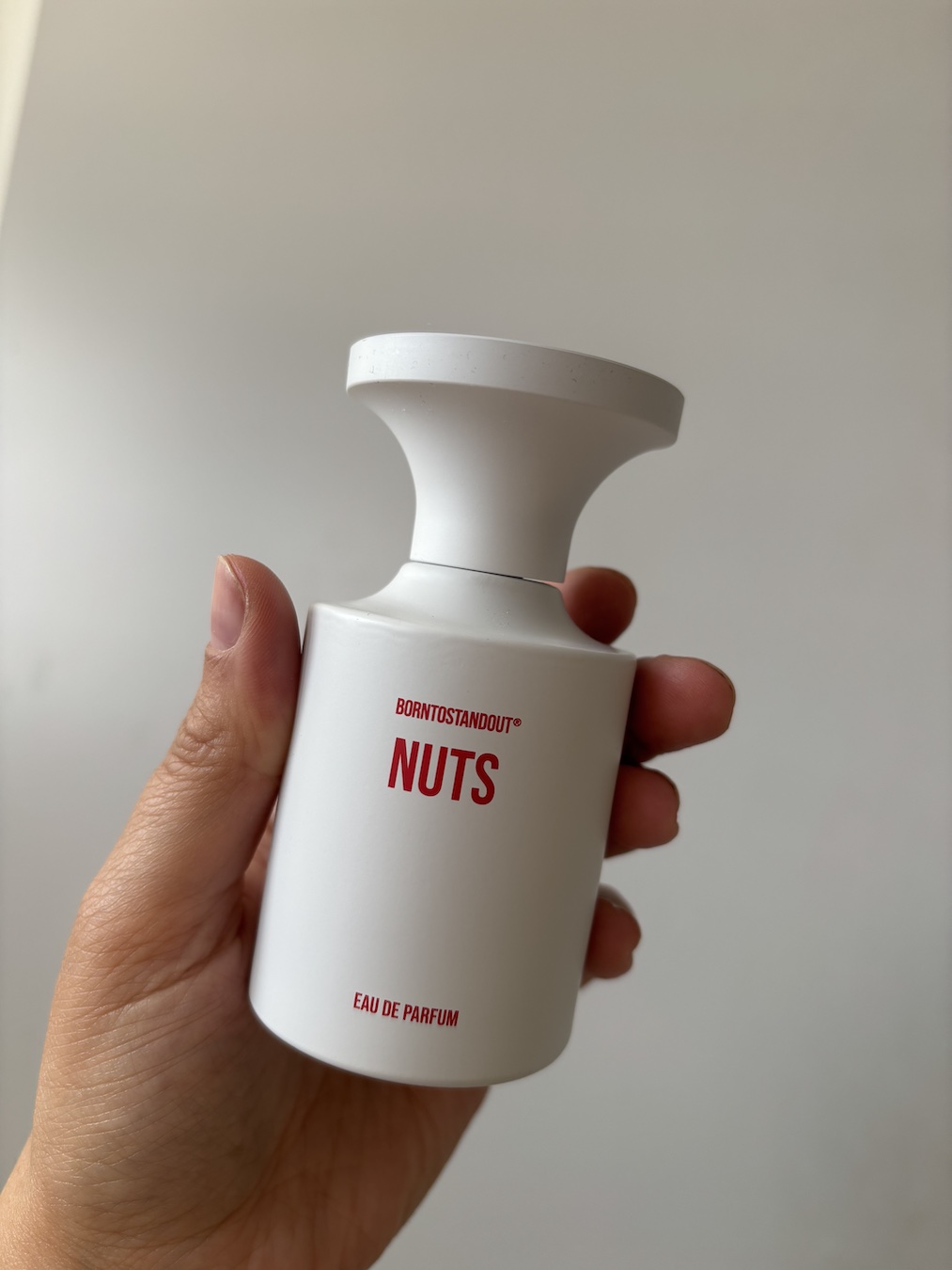 Mica Ricketts holding BORNTOSTANDOUT Nuts