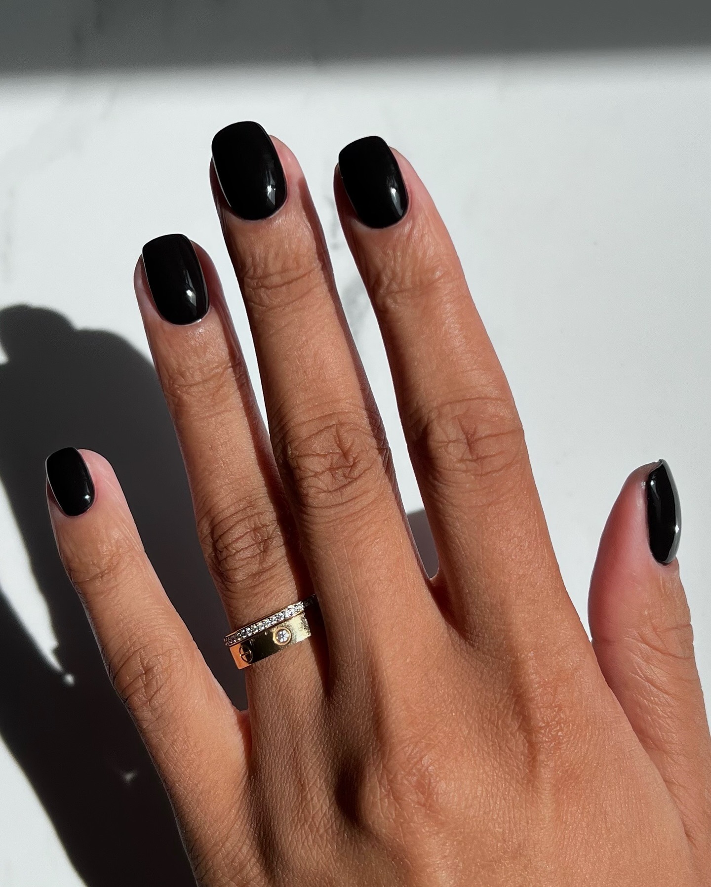A glossy black manicure