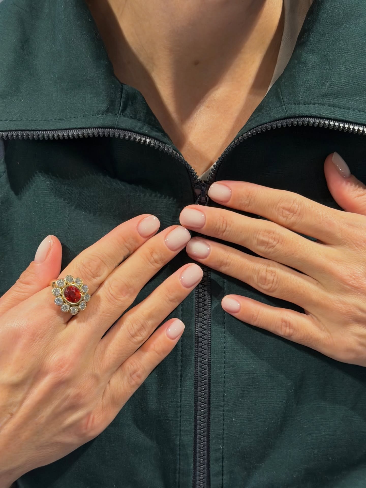 Lily Allen wearing a green jacket with a milky manicure