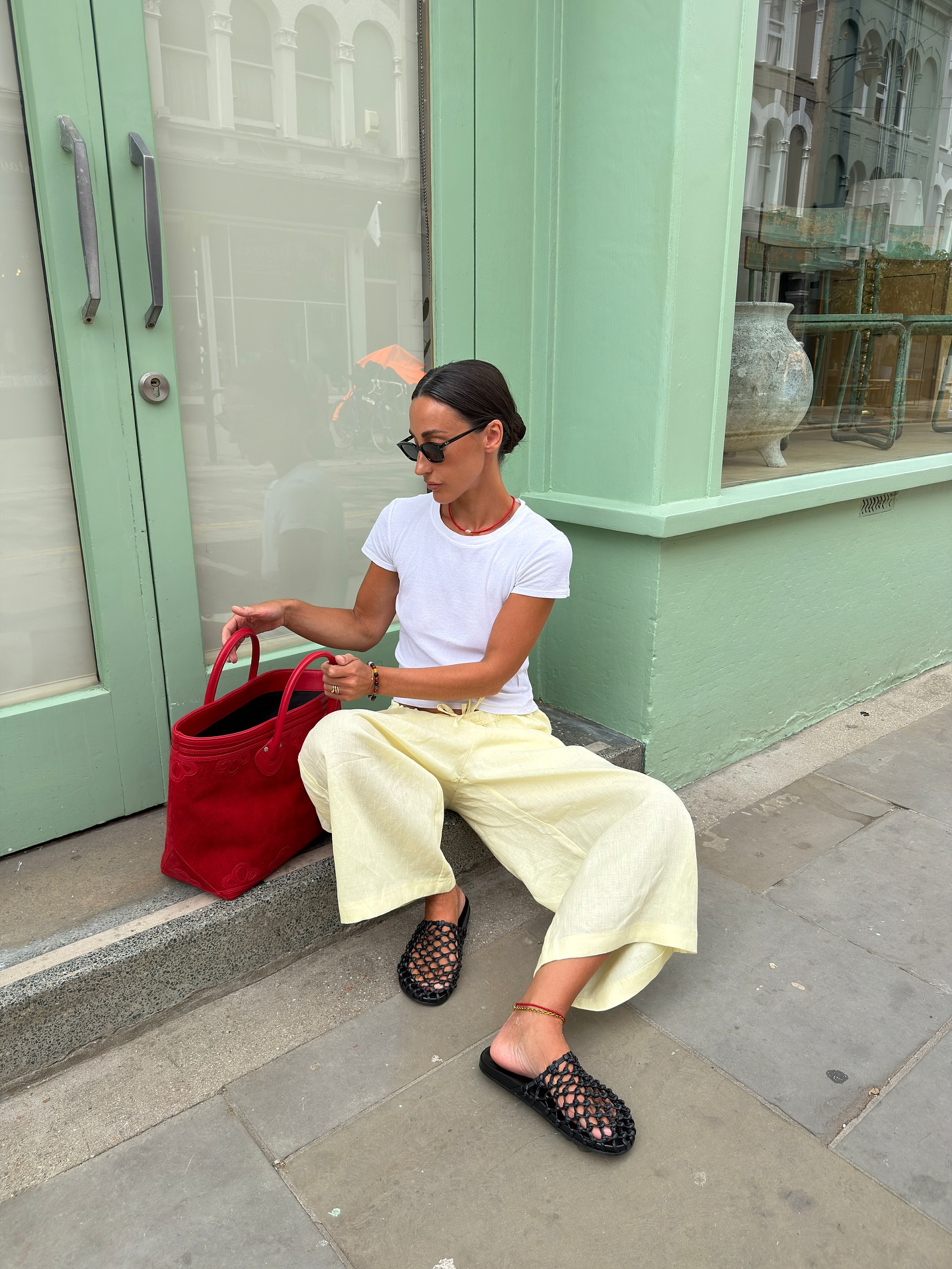 Emswells wears a white tee, yellow trousers and cage shoes