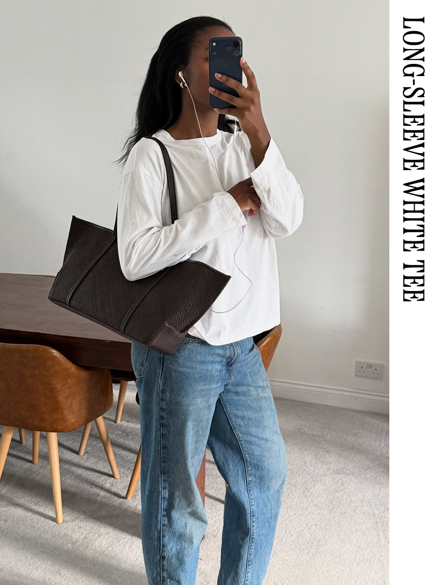 Woman wearing a long-sleeve white T-shirt and jeans
