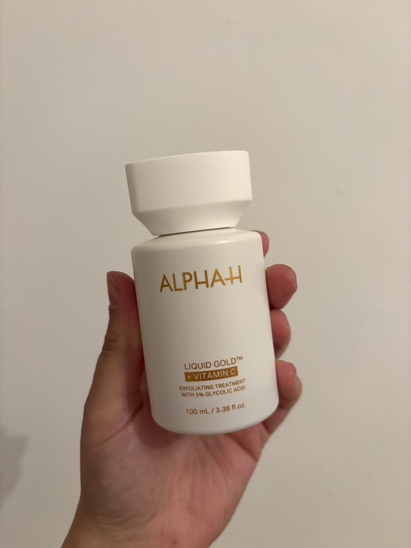Mica Ricketts holding Alpha-H Liquid Gold + Vitamin C