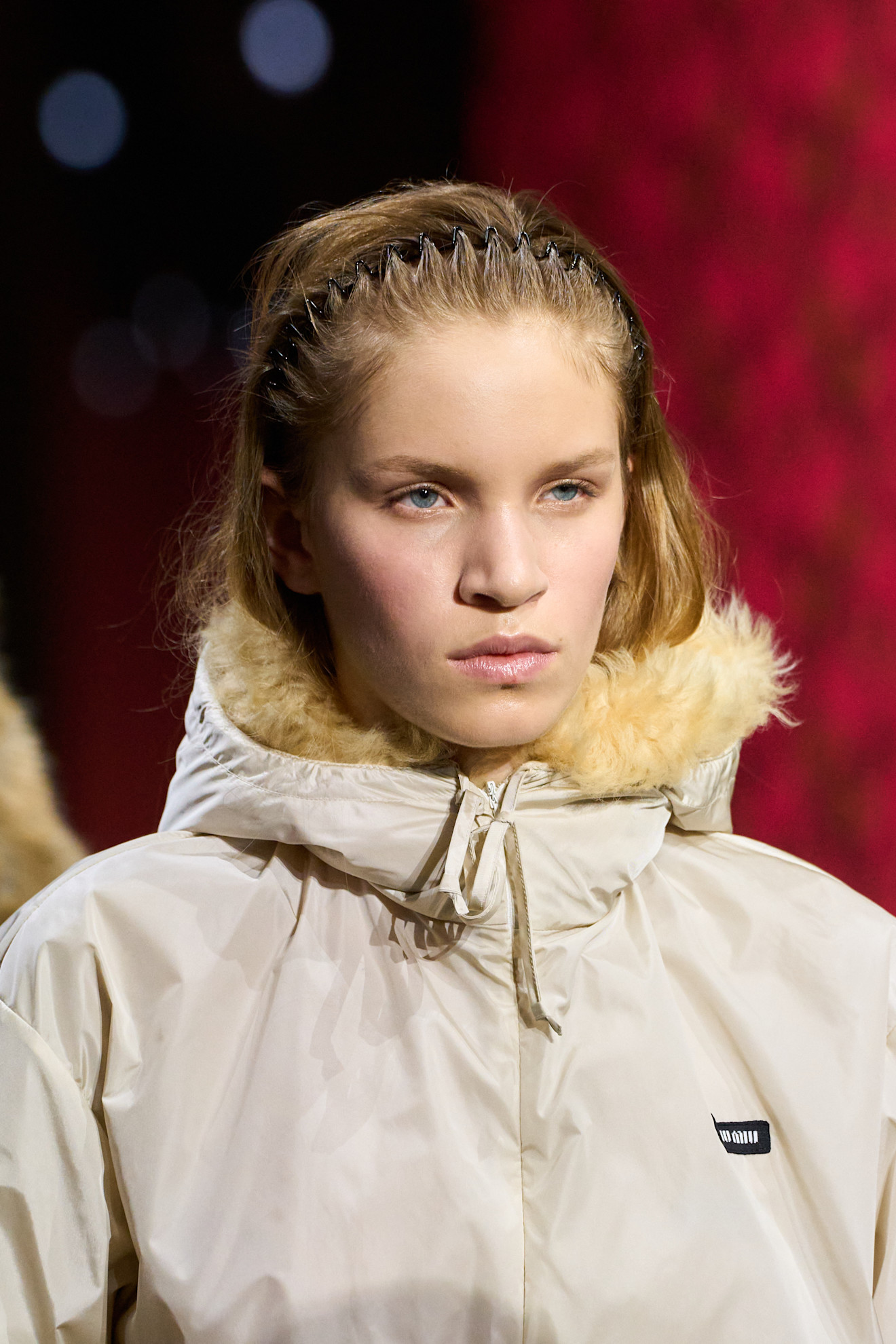 a model wears a zig-zag headband on the runway.
