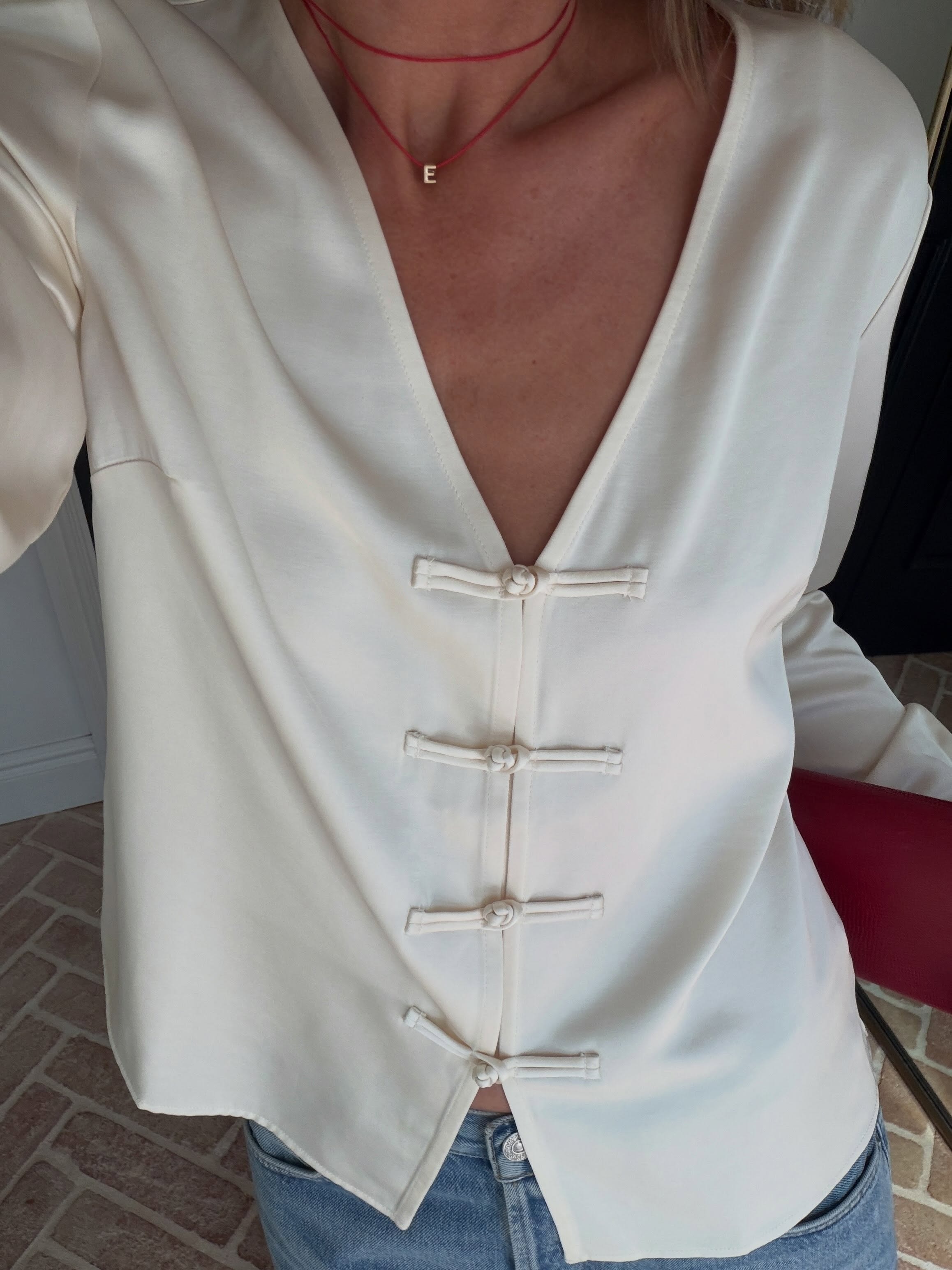 Woman wears Aligne saffron knot tie shirt