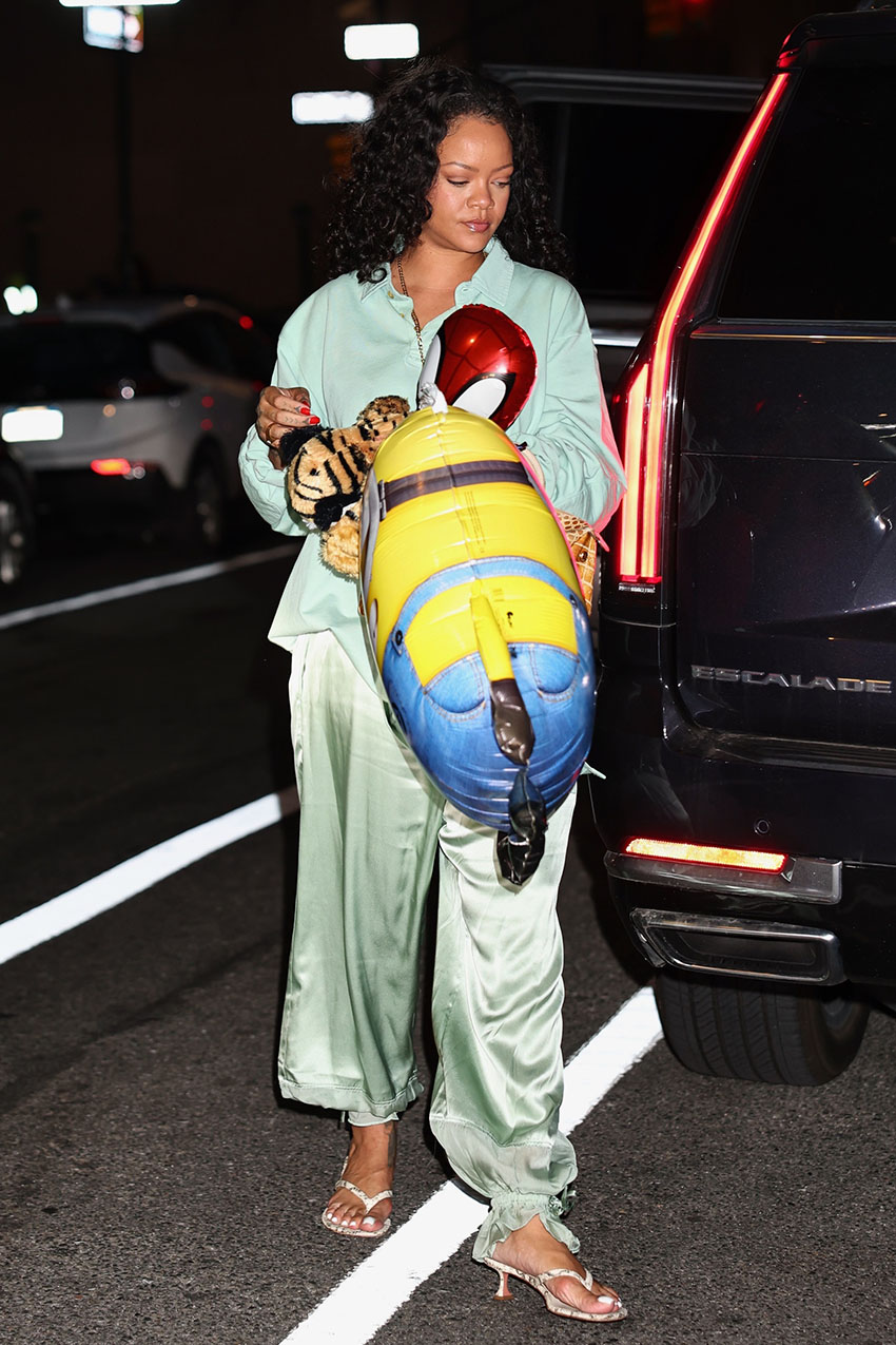 Rihanna wearing a teal polo longsleeve shirt, balloon pants, and snakeskin sandals