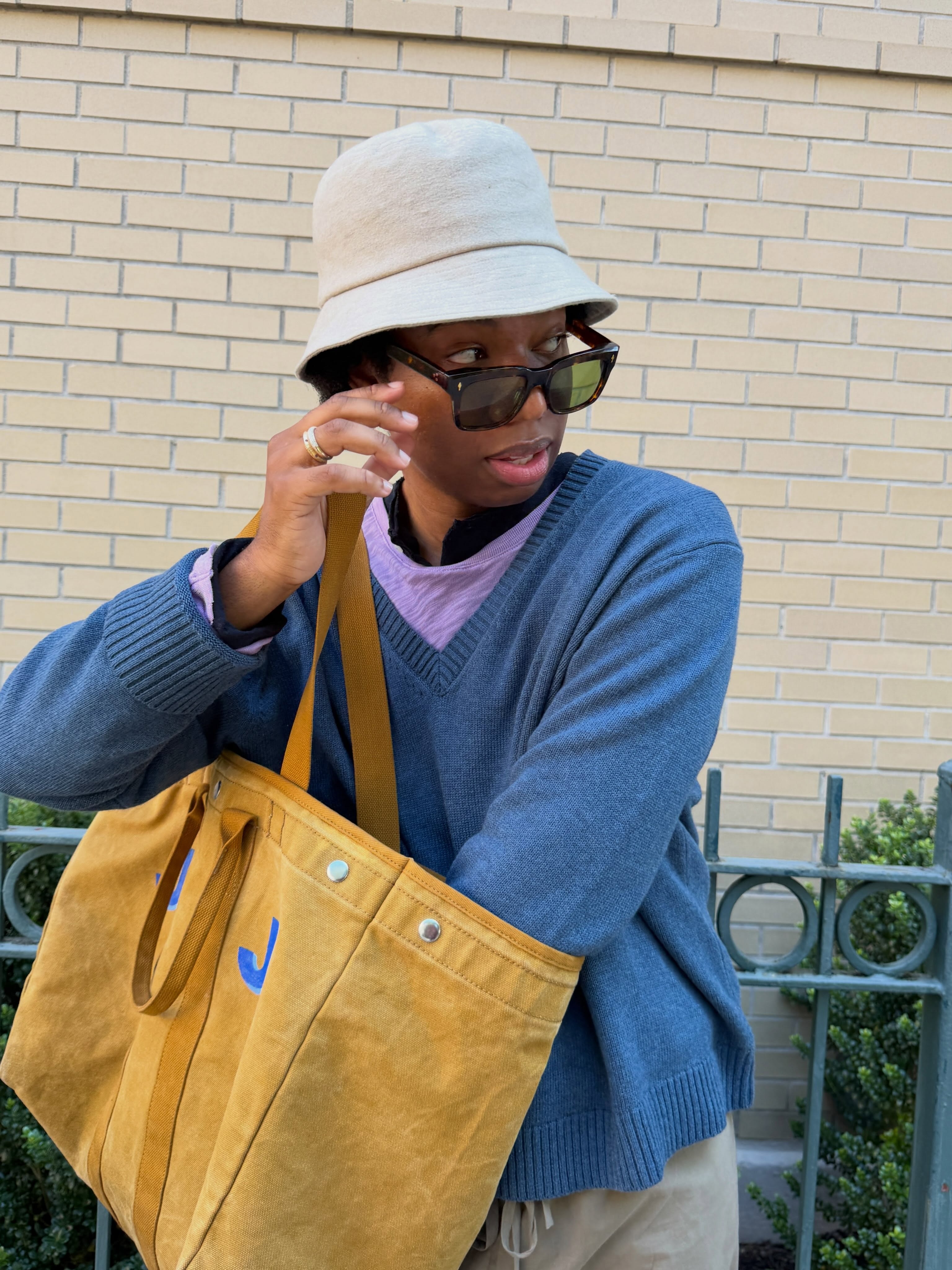 Fashion writer Jalil Johnson wears the Alex Mill Everday Weekday monogrammed tote bag.