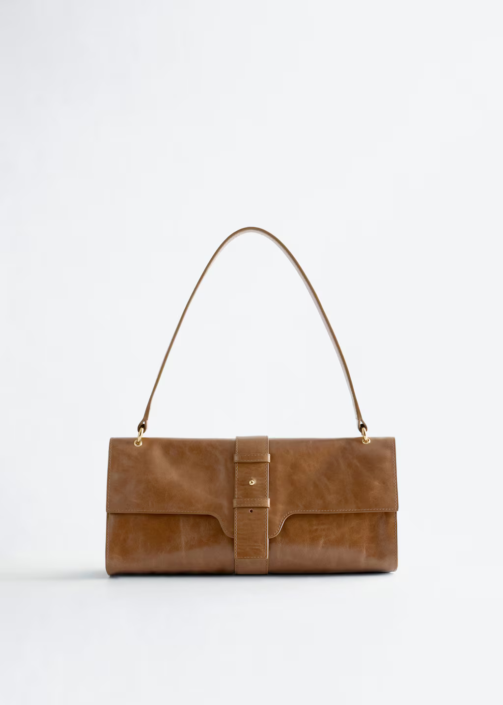 A brown leather & Other Stories bag.