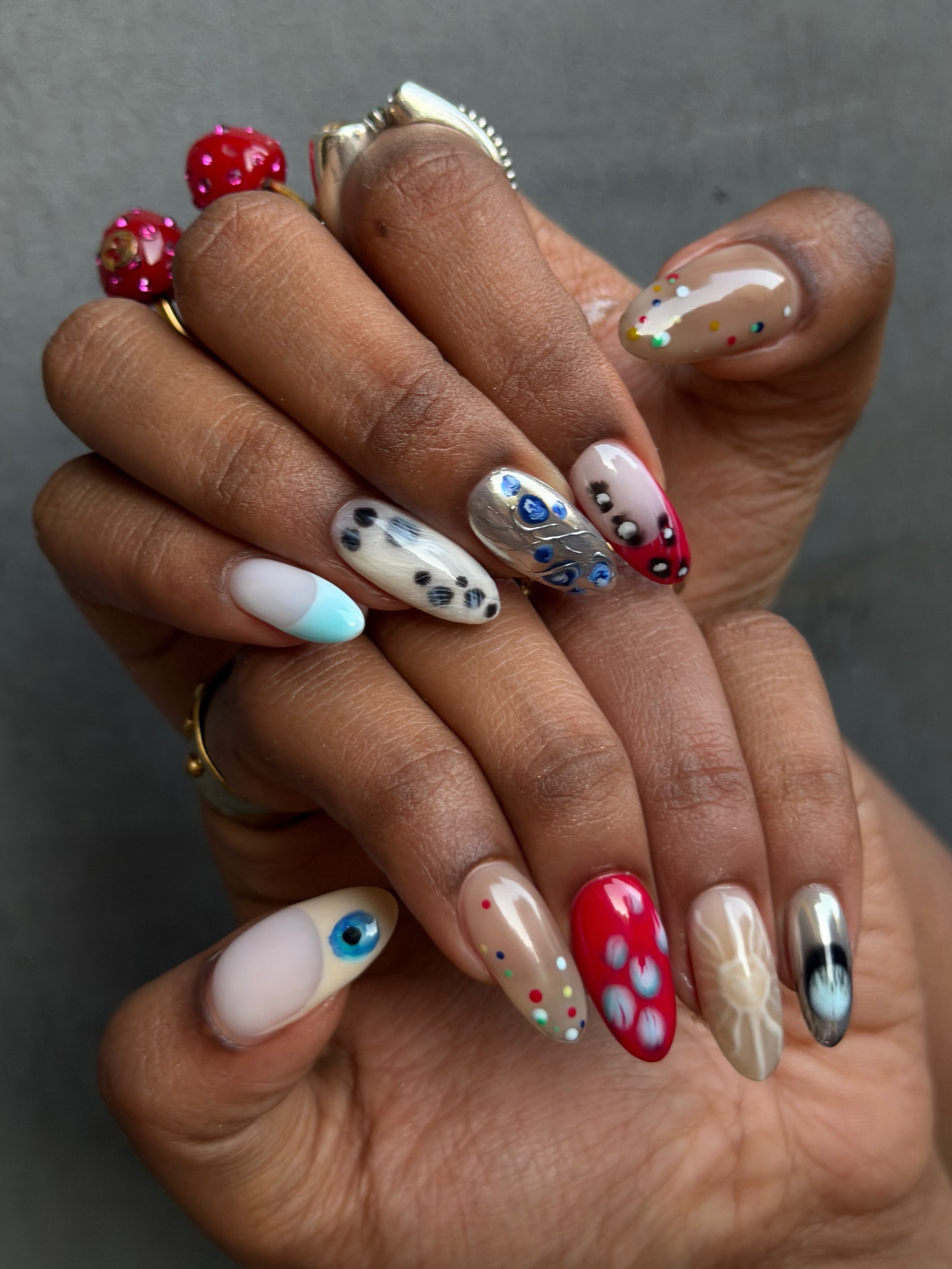 Mismatched feather-inspired nails.