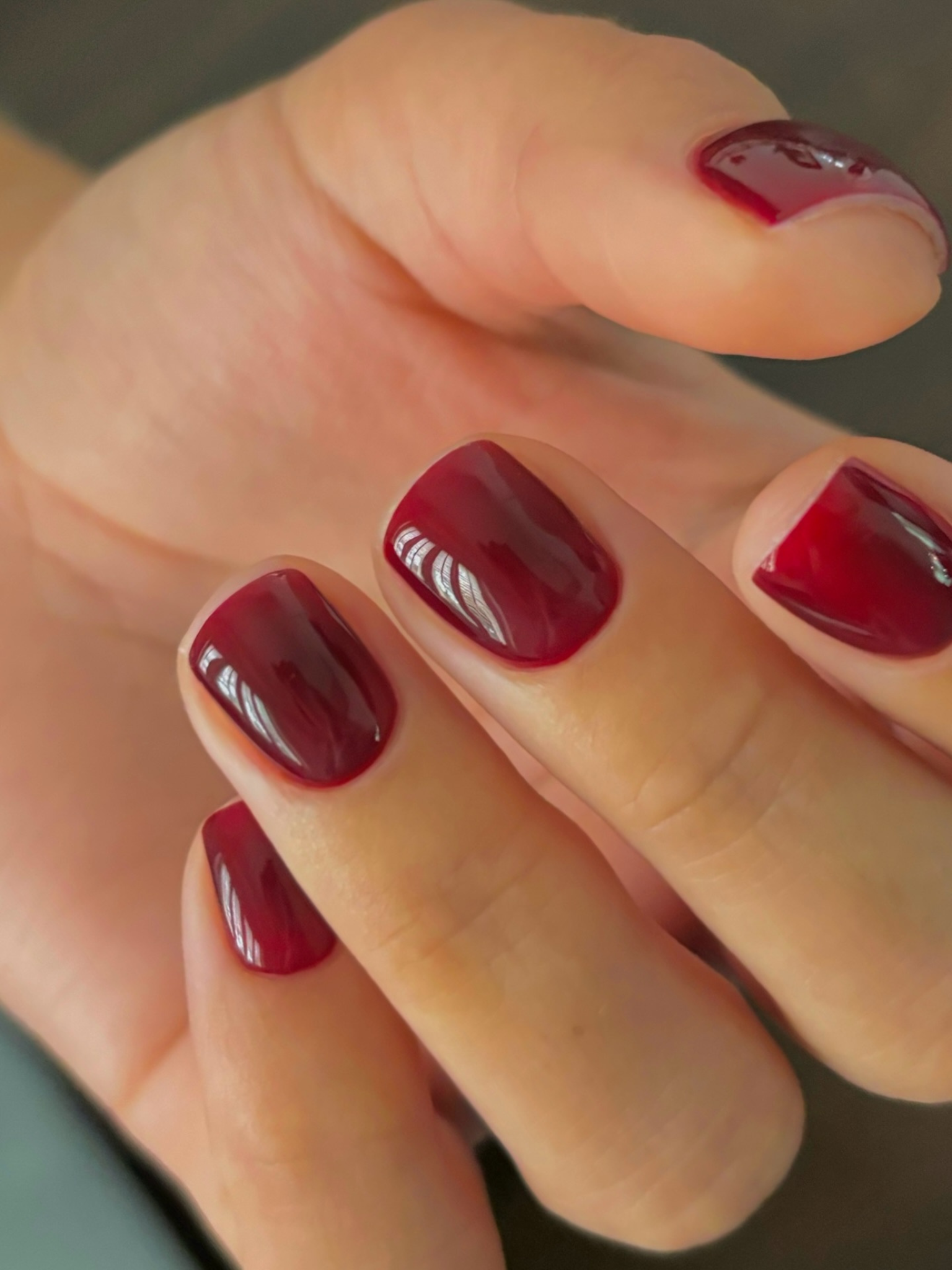 Cherry red short nails.