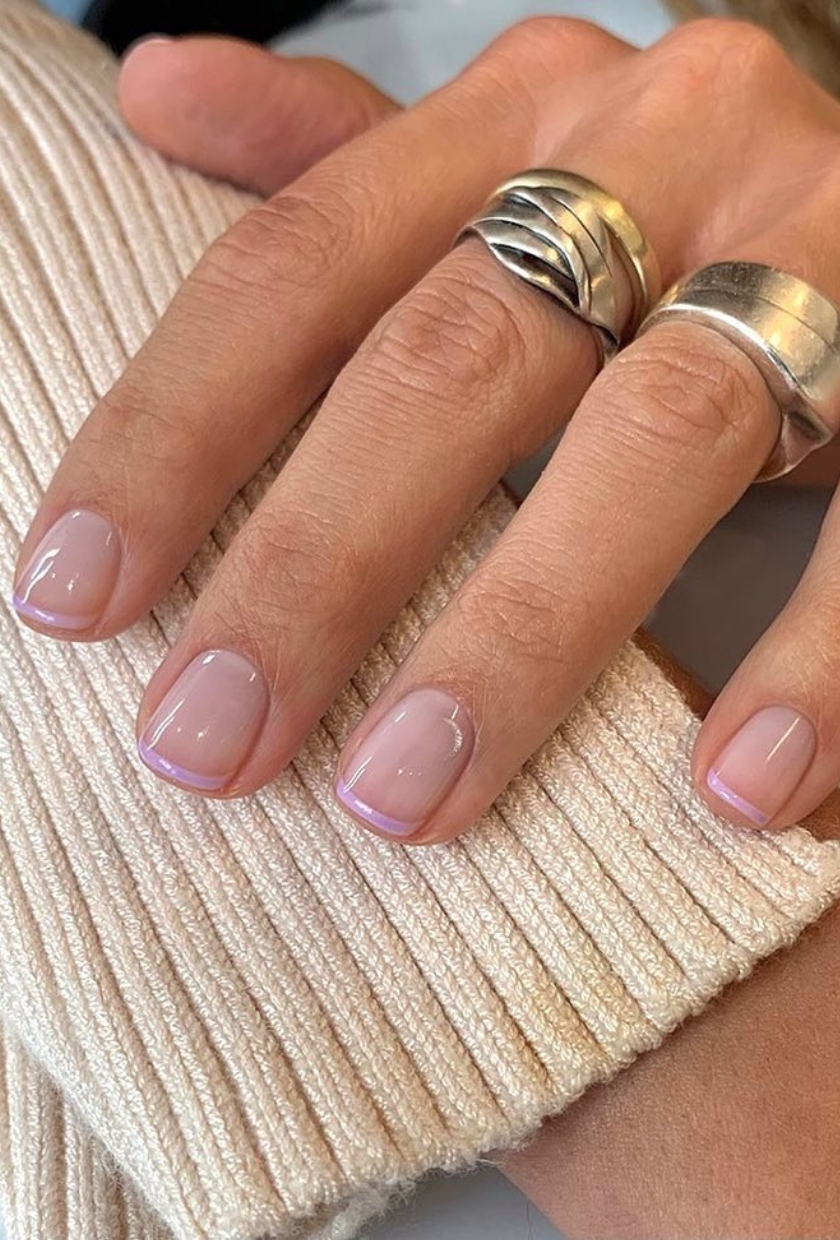 a close up shot of mauve milk French-tip nails