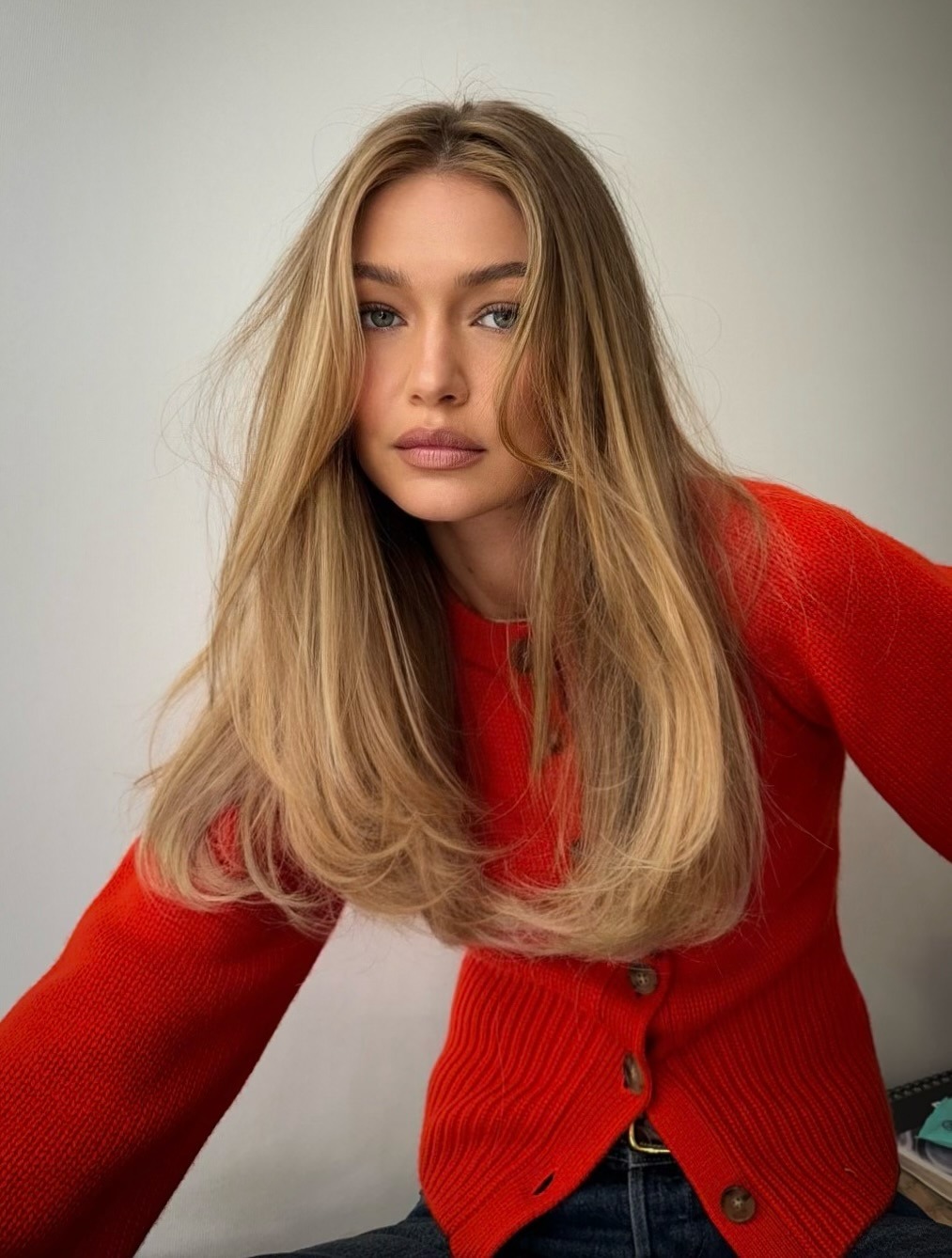 Gigi Hadid with soft blonde hair colour and C-cut curls