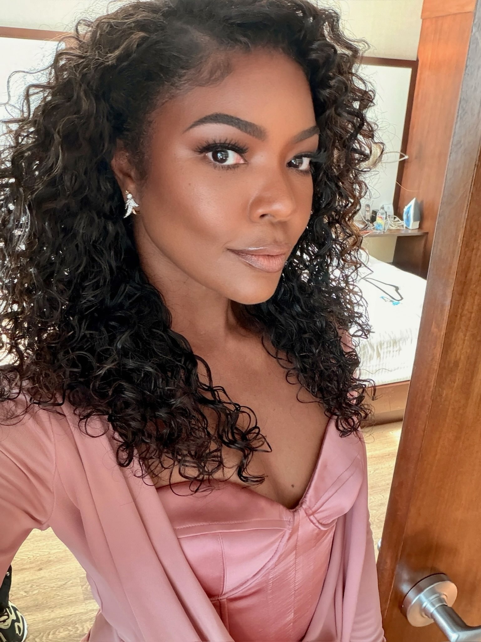 Gabrielle Union wears a long sleeved pink Zuhair Murad fall 2026 dress to Coco Jones's wedding.