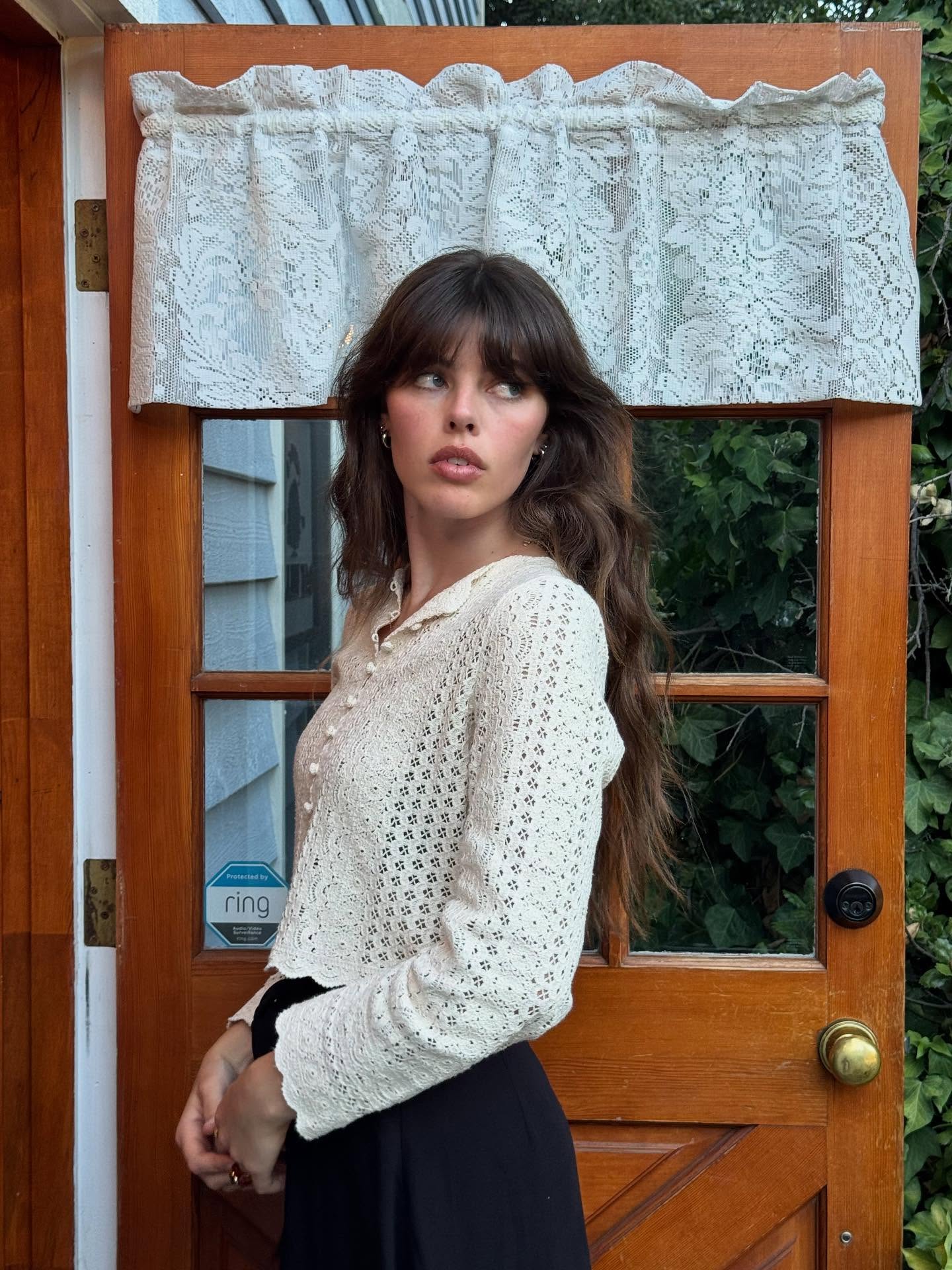 Influencer Hannah Shepherd wearing a crochet cardigan.