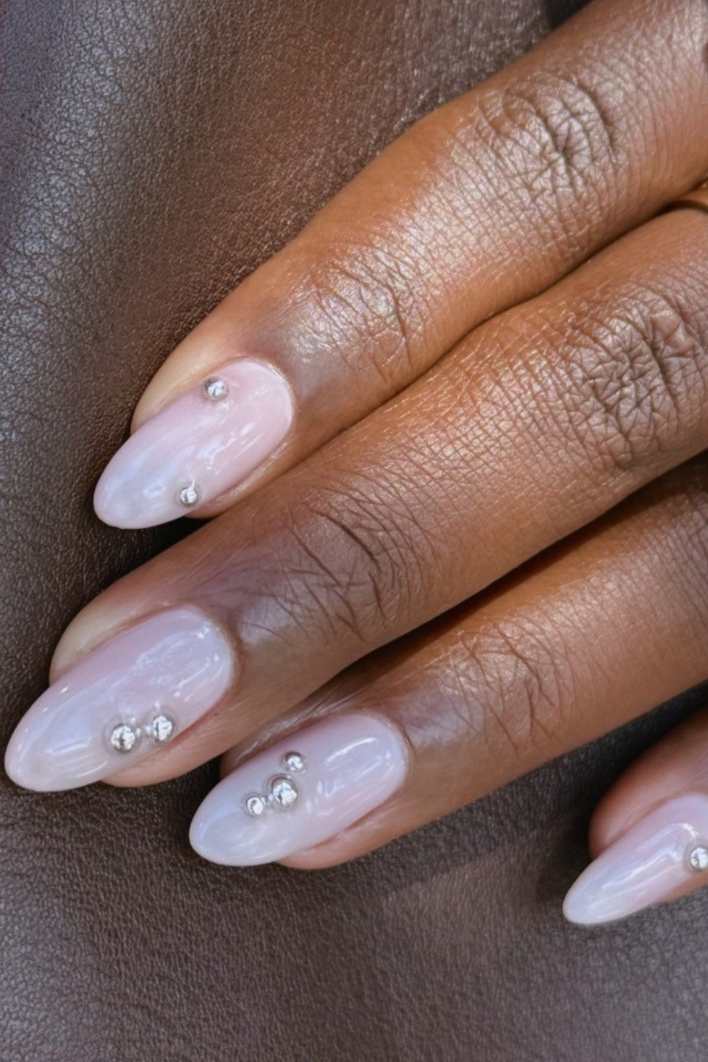 A long milky manicure with silver gems by @nailartbyqueenie