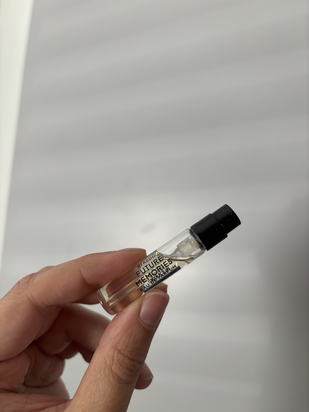 Mica Ricketts holding tester of Byredo Future Memories