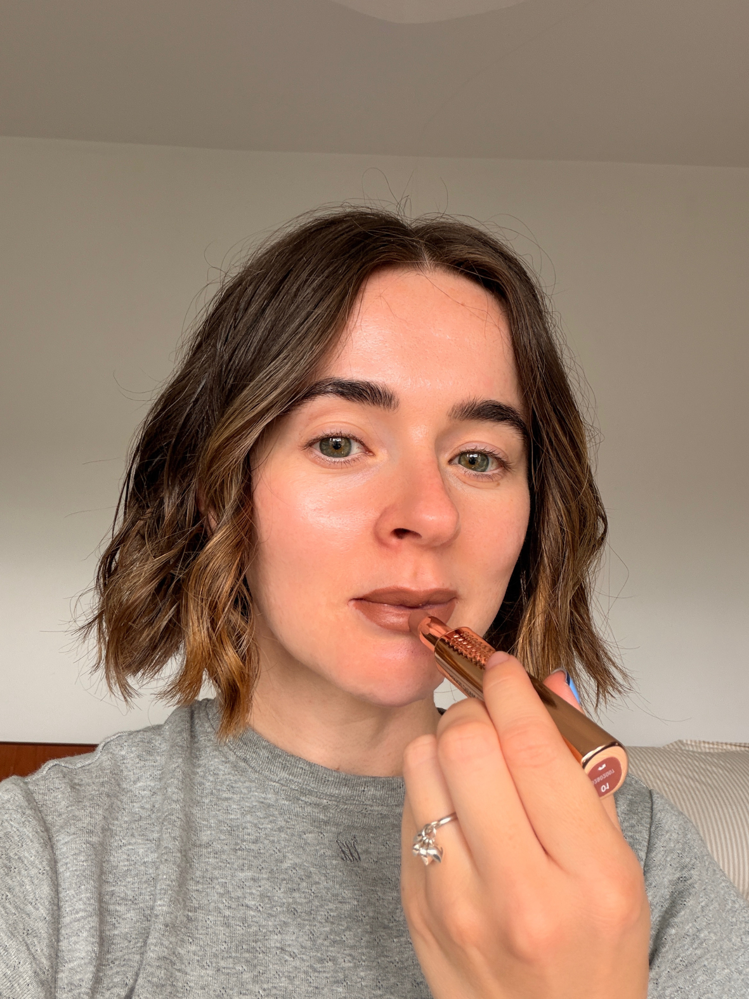 Freelance beauty editor Grace Day applying a Kiko brown lipstick