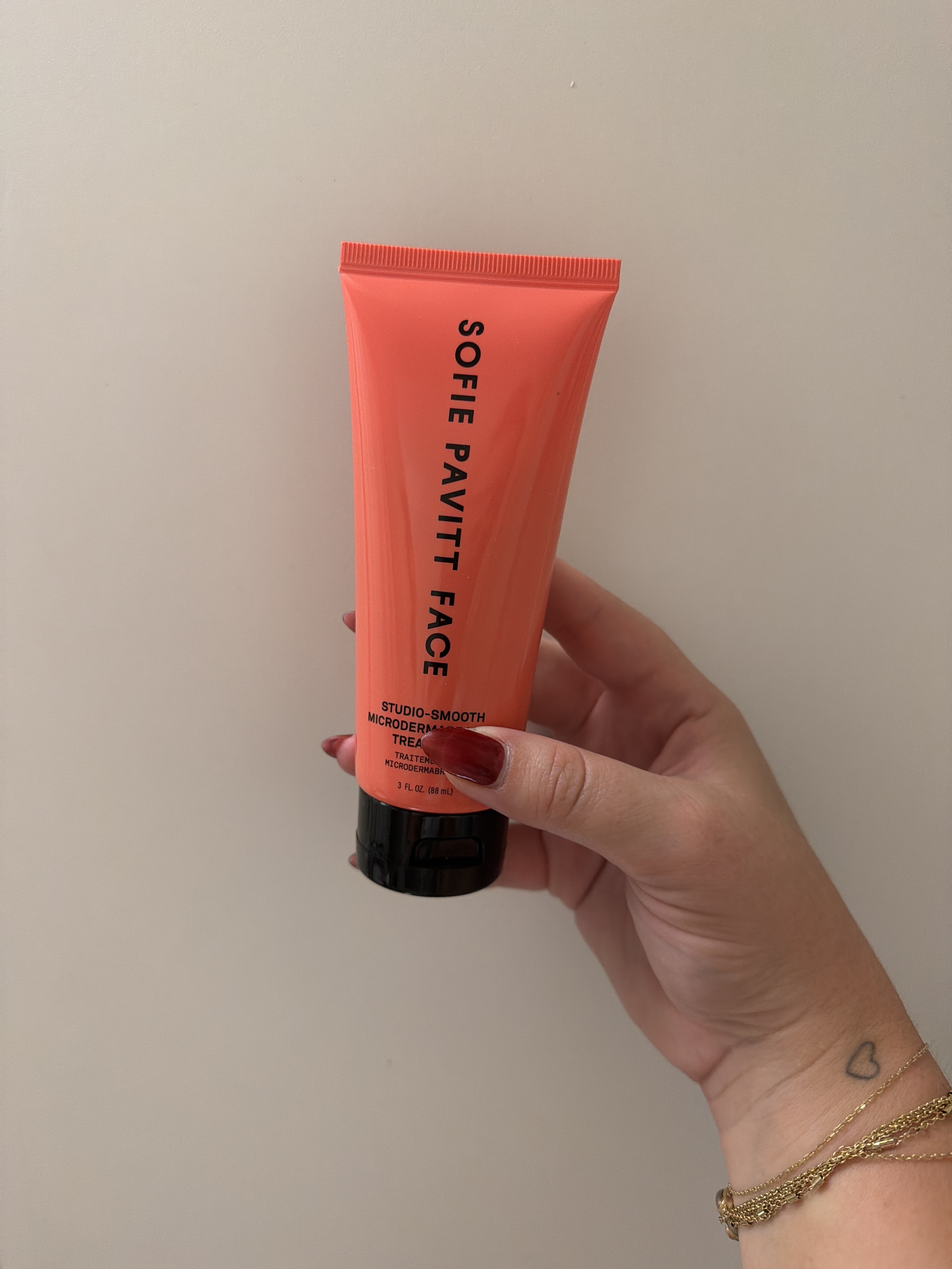 An image of someone holding the Sofie Pavitt Face Studio-Smooth Scrub.