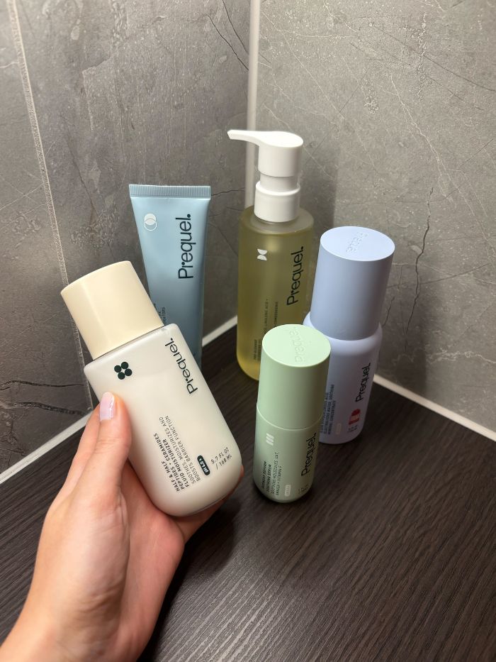 Prequel skincare in a marble bathroom