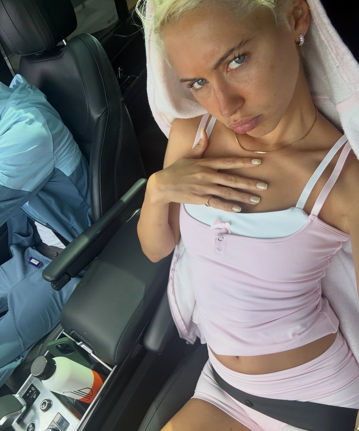 Model Iris Law wears pink biker shorts with a pink tank top.