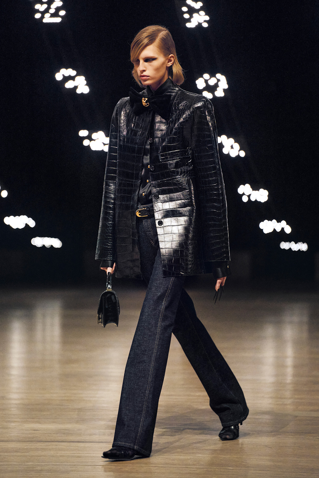 Model from the Khaite fall/winter 2026 show wearing a croc-embossed black leather jacket.
