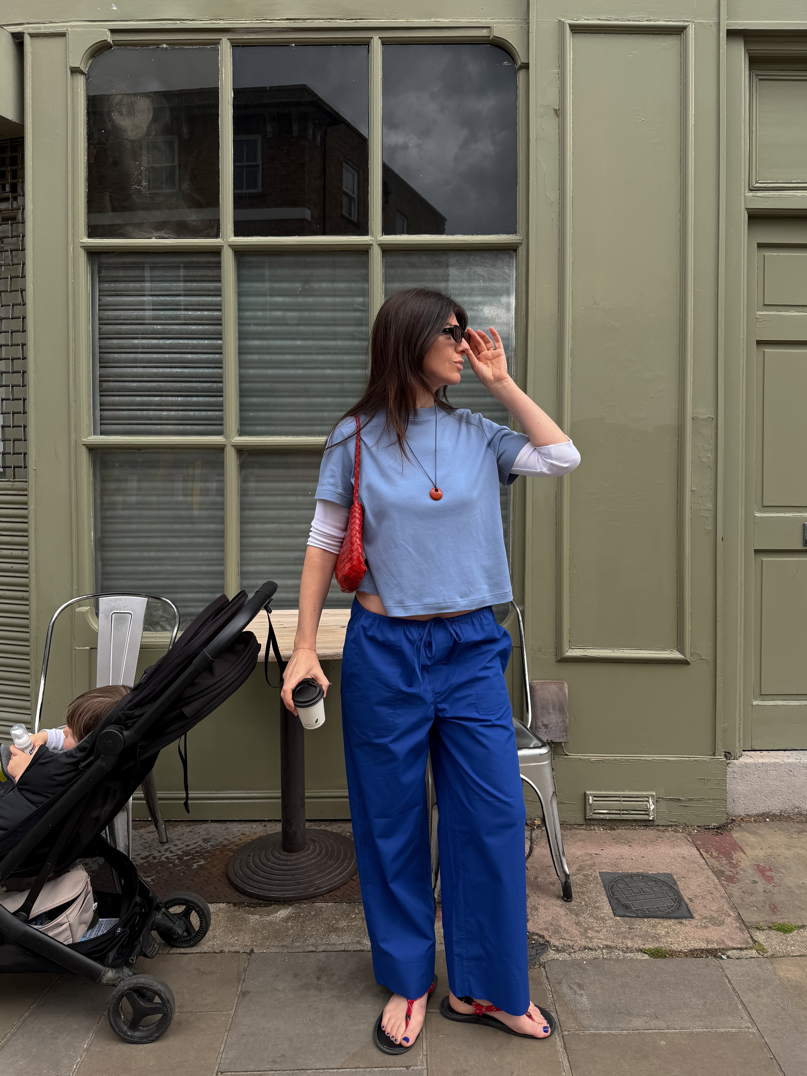 Influencer Francesca Saffari wearing blue short sleeve t-shirt layered over a white long sleeved t-shirt.