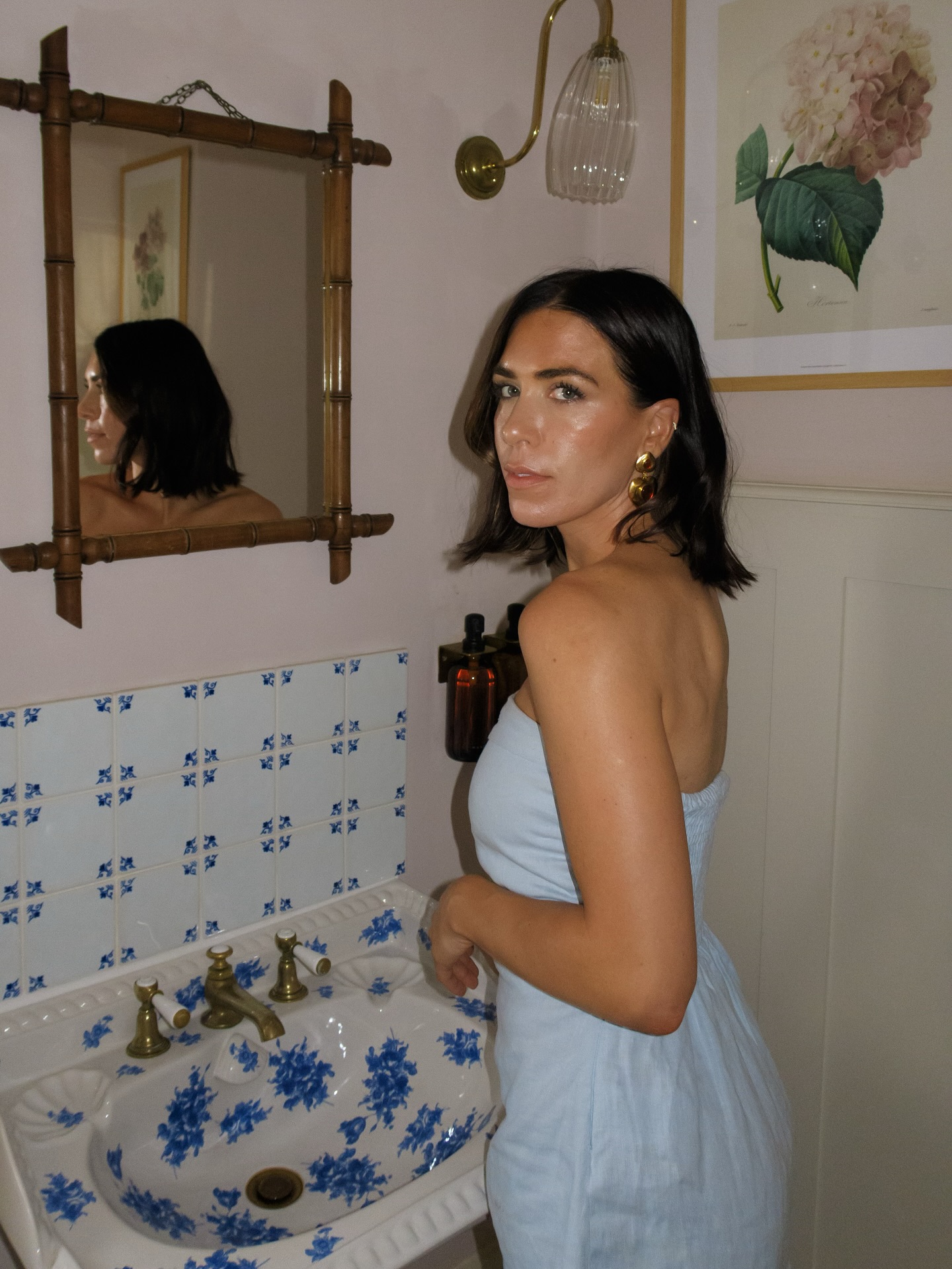 Jessica Skye standing in front of patterned sink with glowy skin