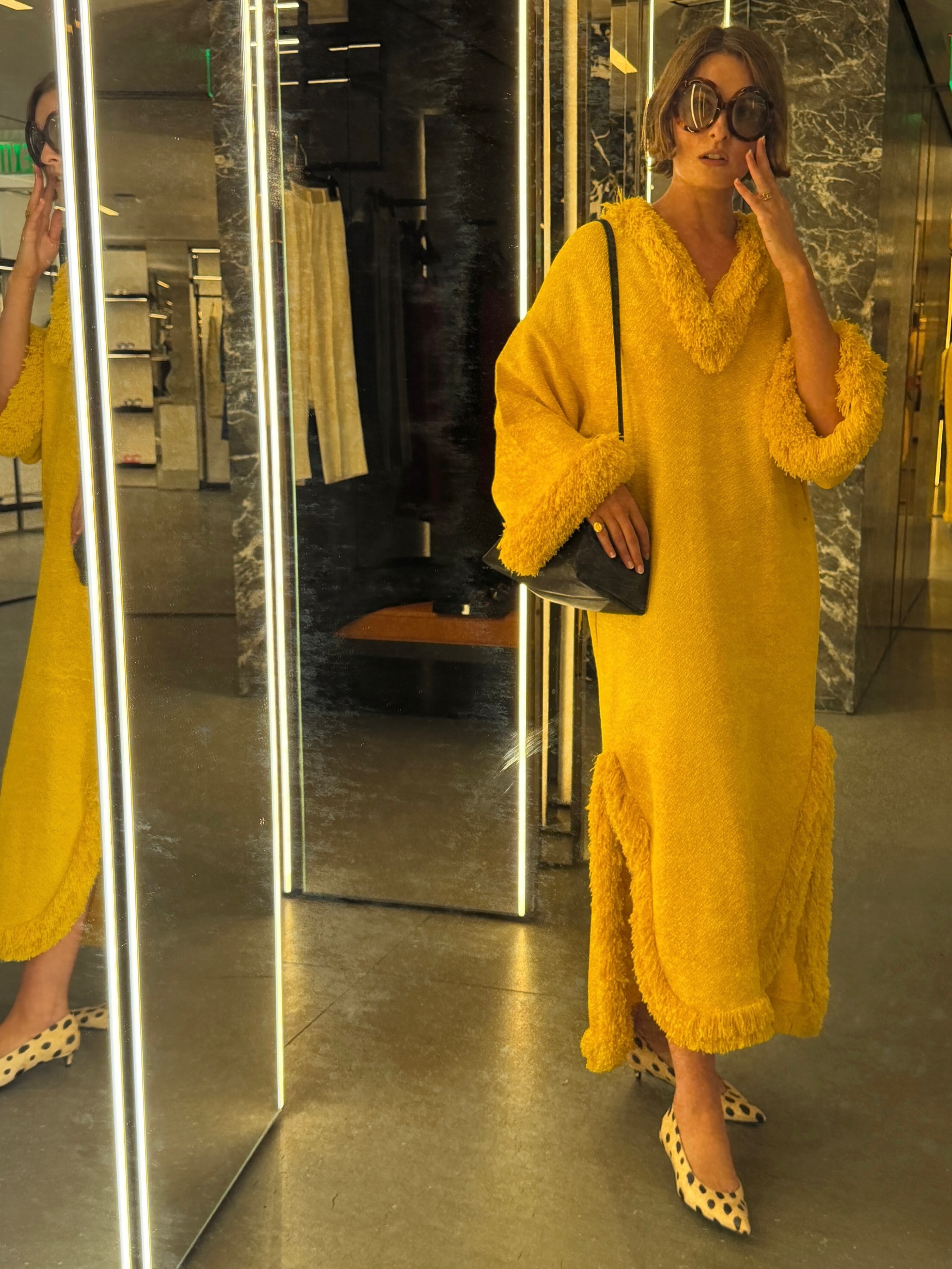 An image of @christietyler  wearing a yellow kaftan from Celine.