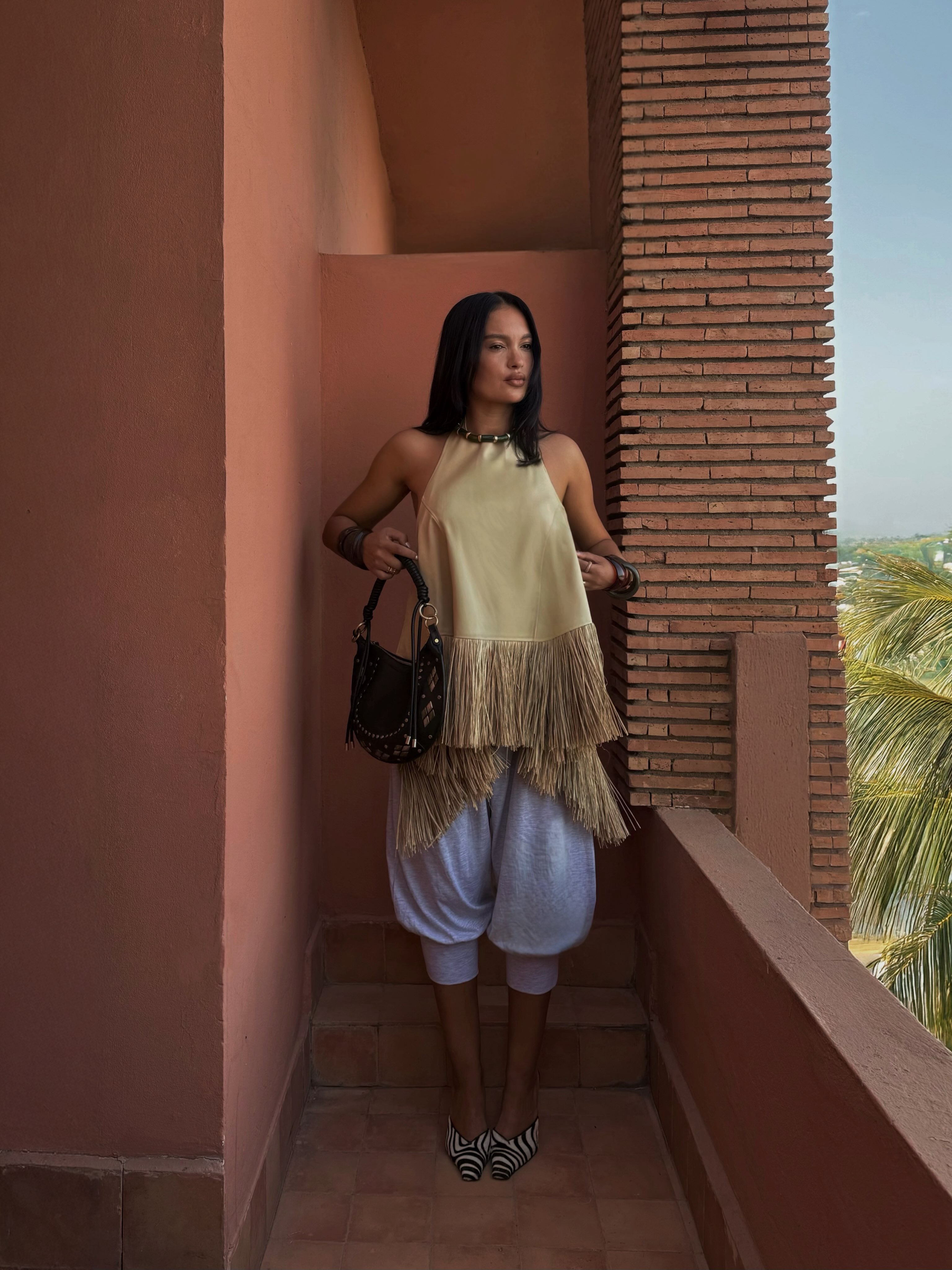 A woman wearing fall shoes with capri pants in 2026.