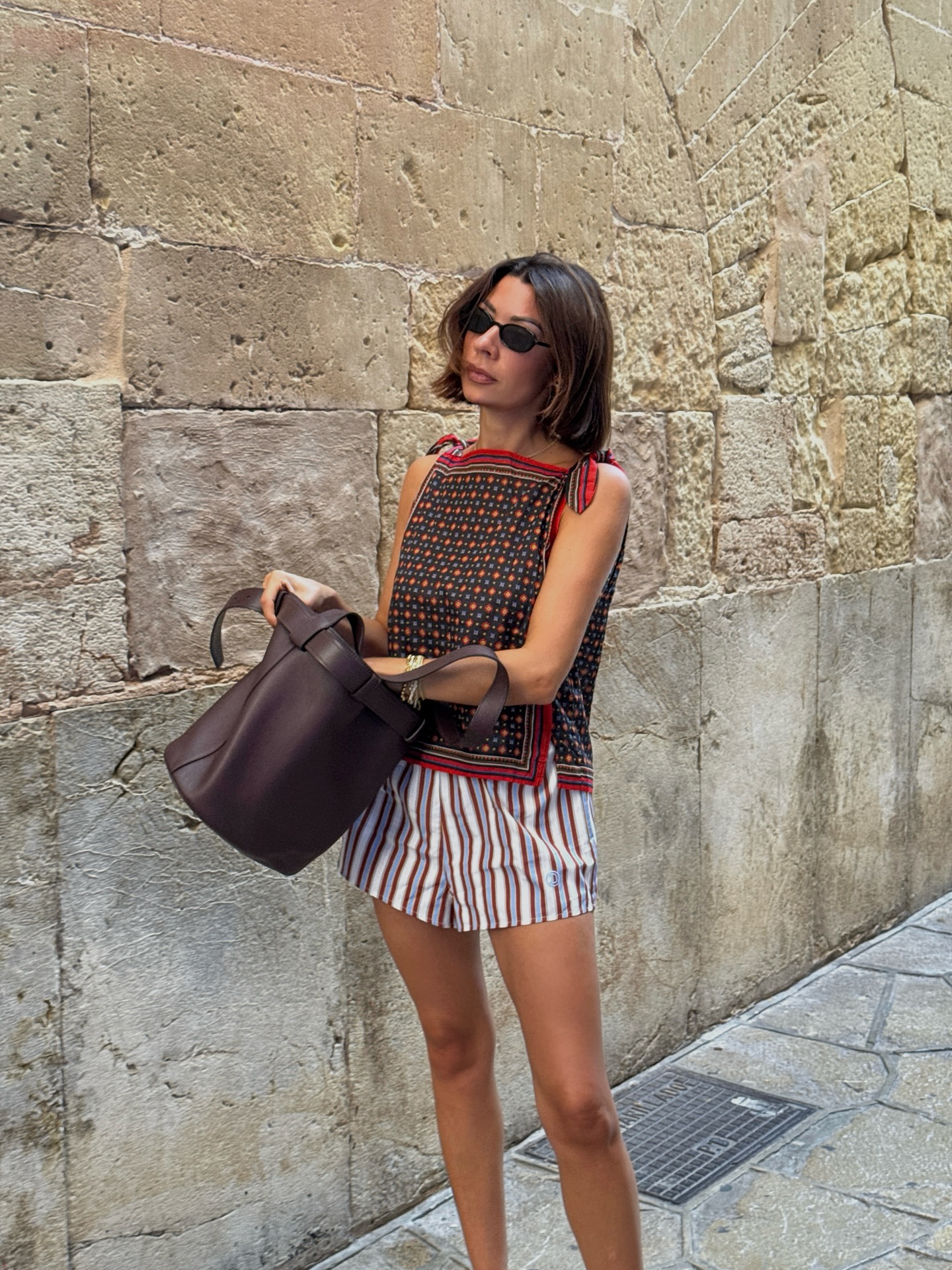 An image of @smythsisters  wearing a Doen blouse with striped shorts.