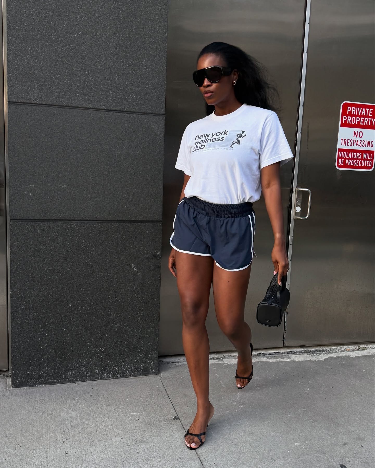 @nlmarilyn wearing athletic shorts and a graphic tee.