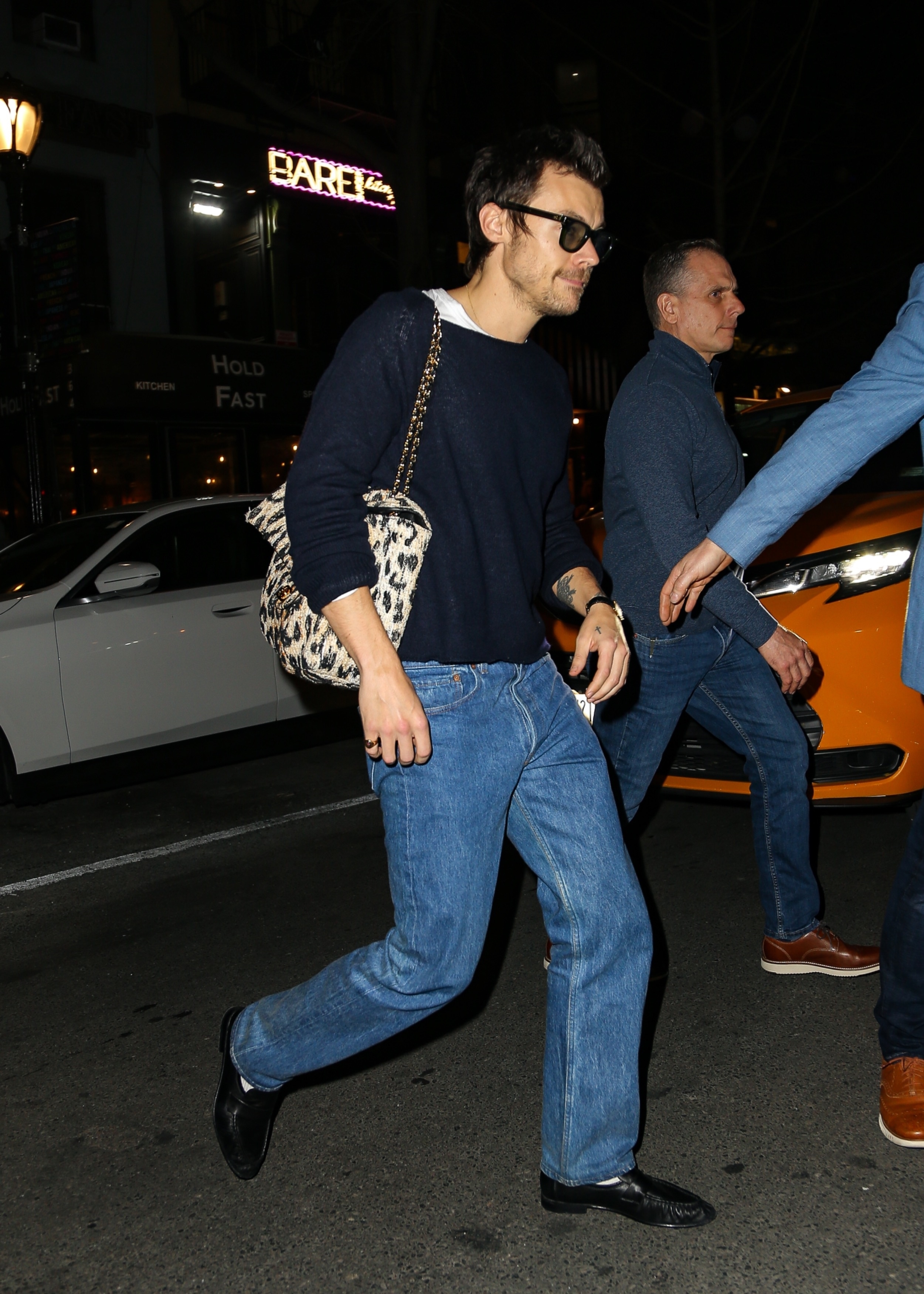 An image of Harry Styles carrying a Chanel Flap Bag.