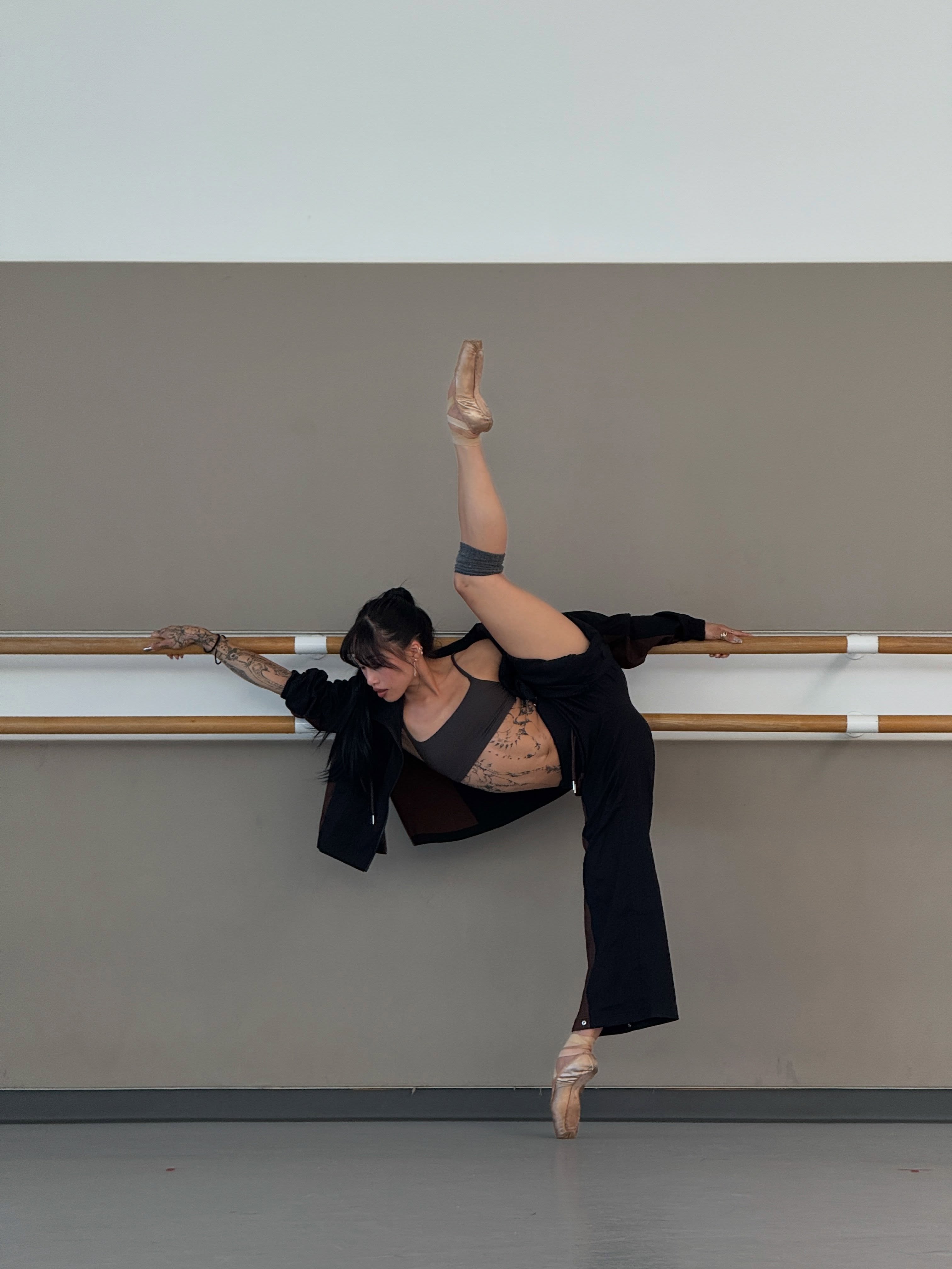 Dancer Madeline Woo doing ballet in black outfit.