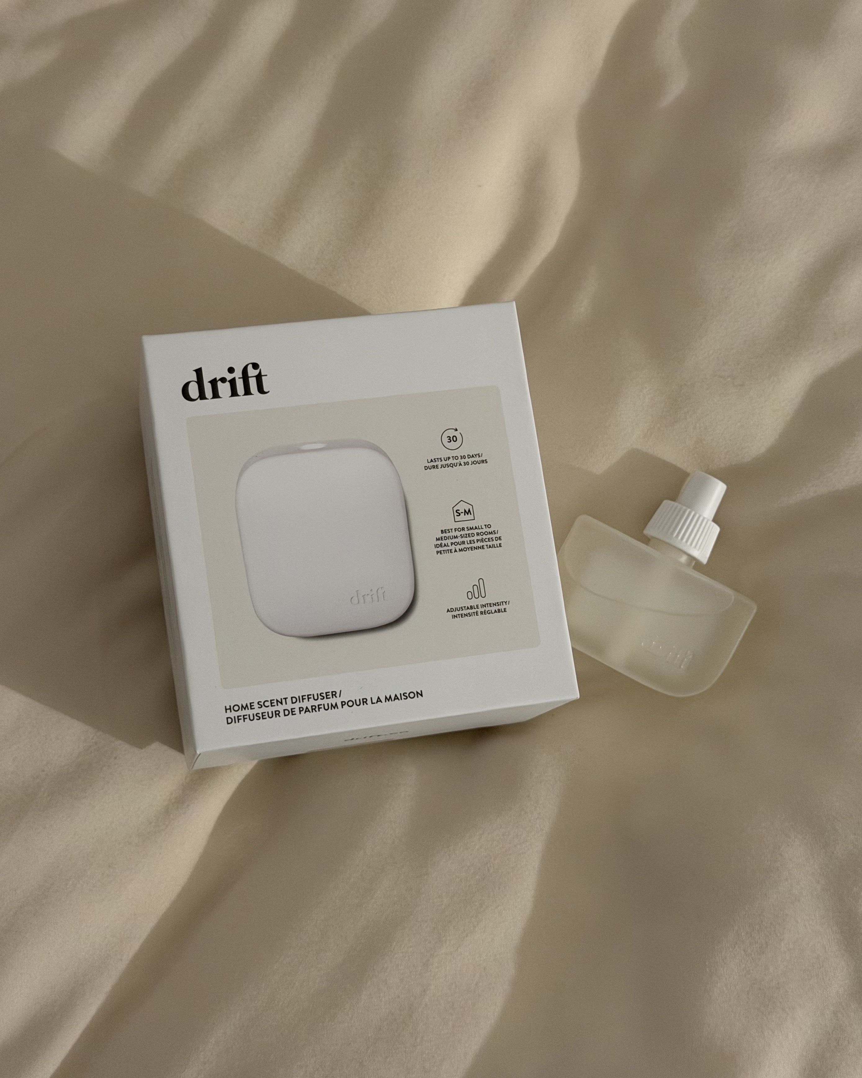 Drift's Home Scent Diffuser in Rest & Relax on a bed.