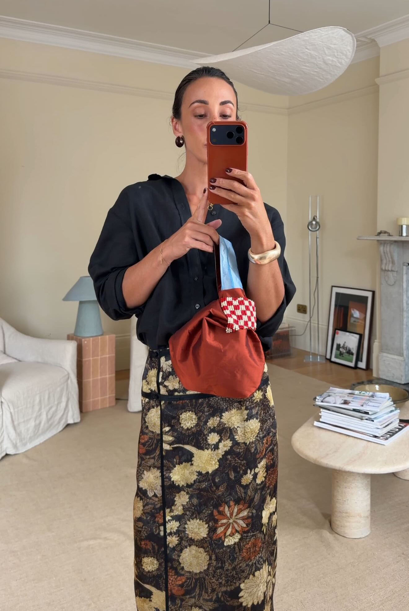 Woman in black shirt and embroidered skirt