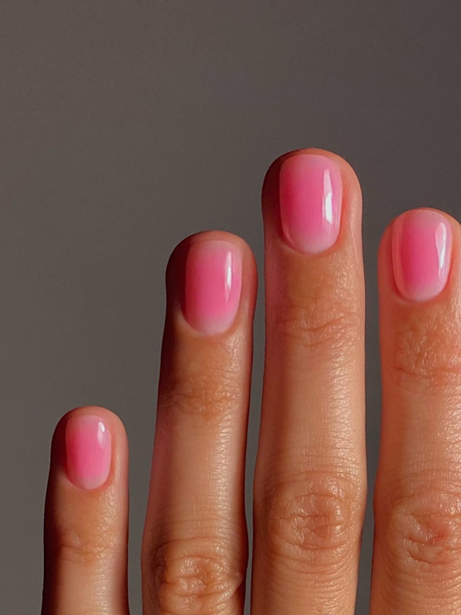 Short nails with a pink jelly effect.