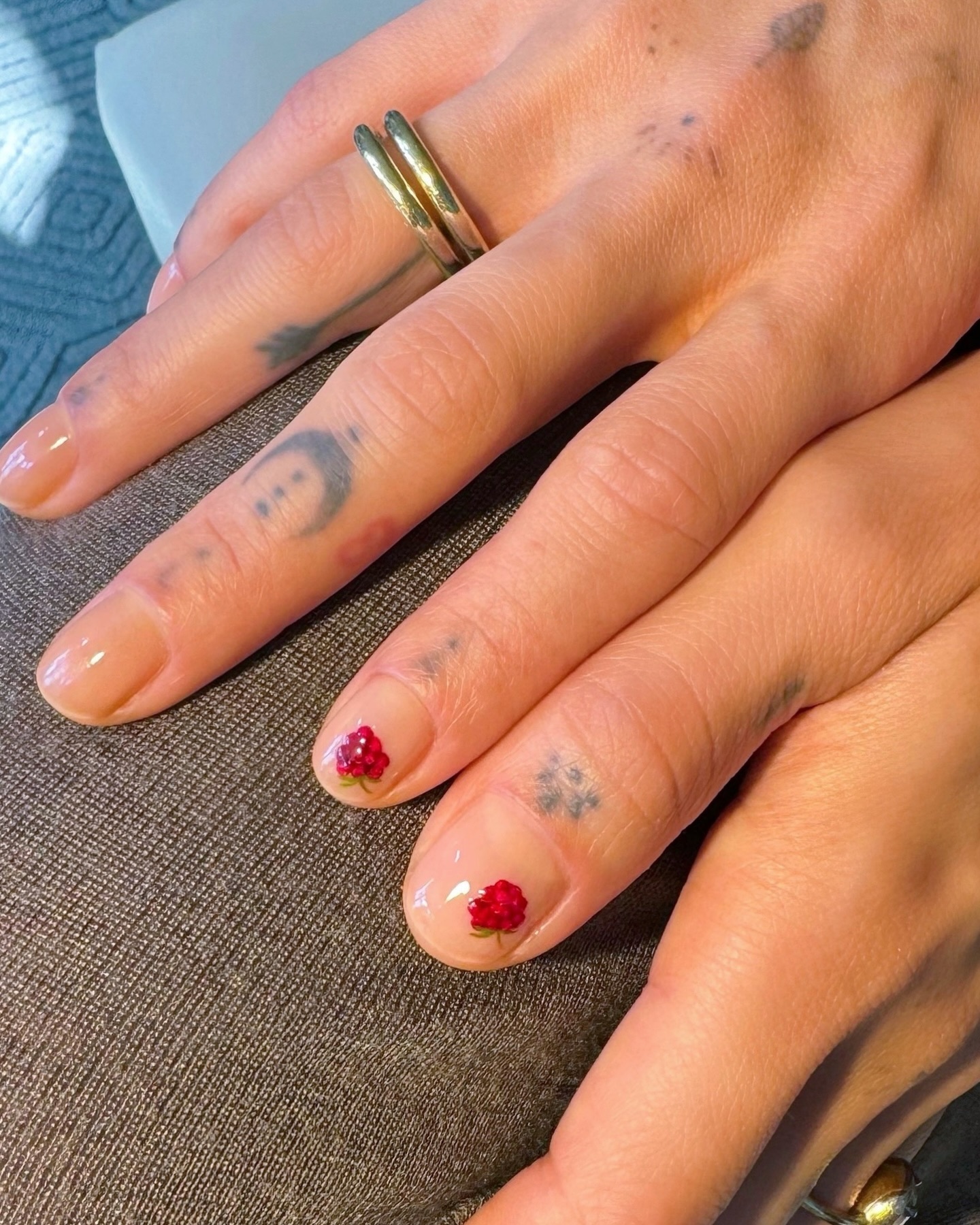 Photo of a red nail design with micro berry art