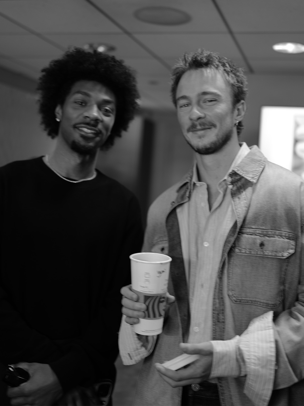 Jonathan Daviss and Drew Starkey holding a Starbuck coffee pose for a photo taken by Chase Stokes.