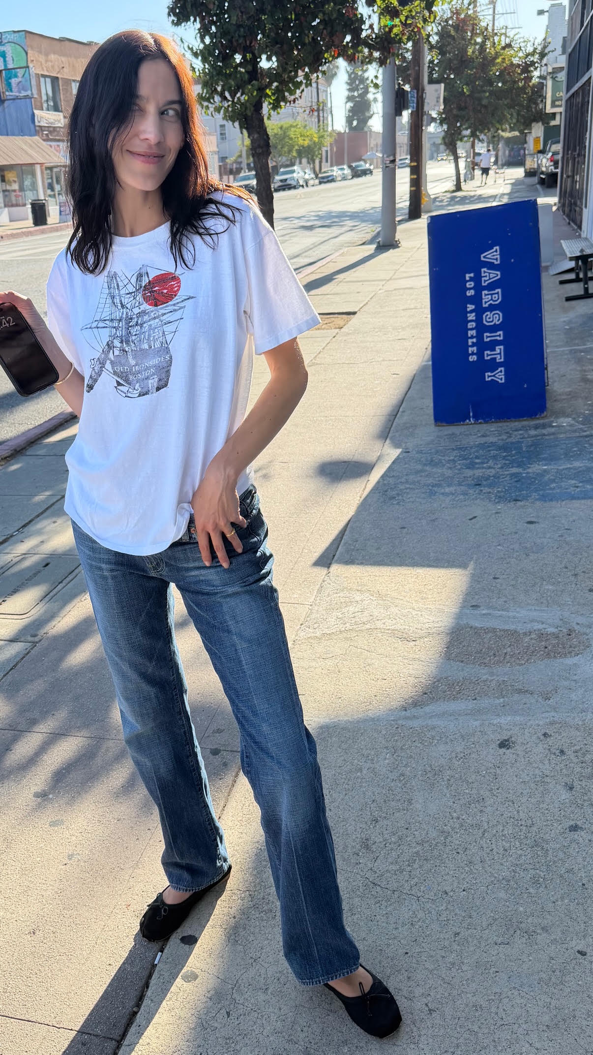 Alexa Chung wears soft ballet flats with jeans and a tee and a butter yellow maxi dress.