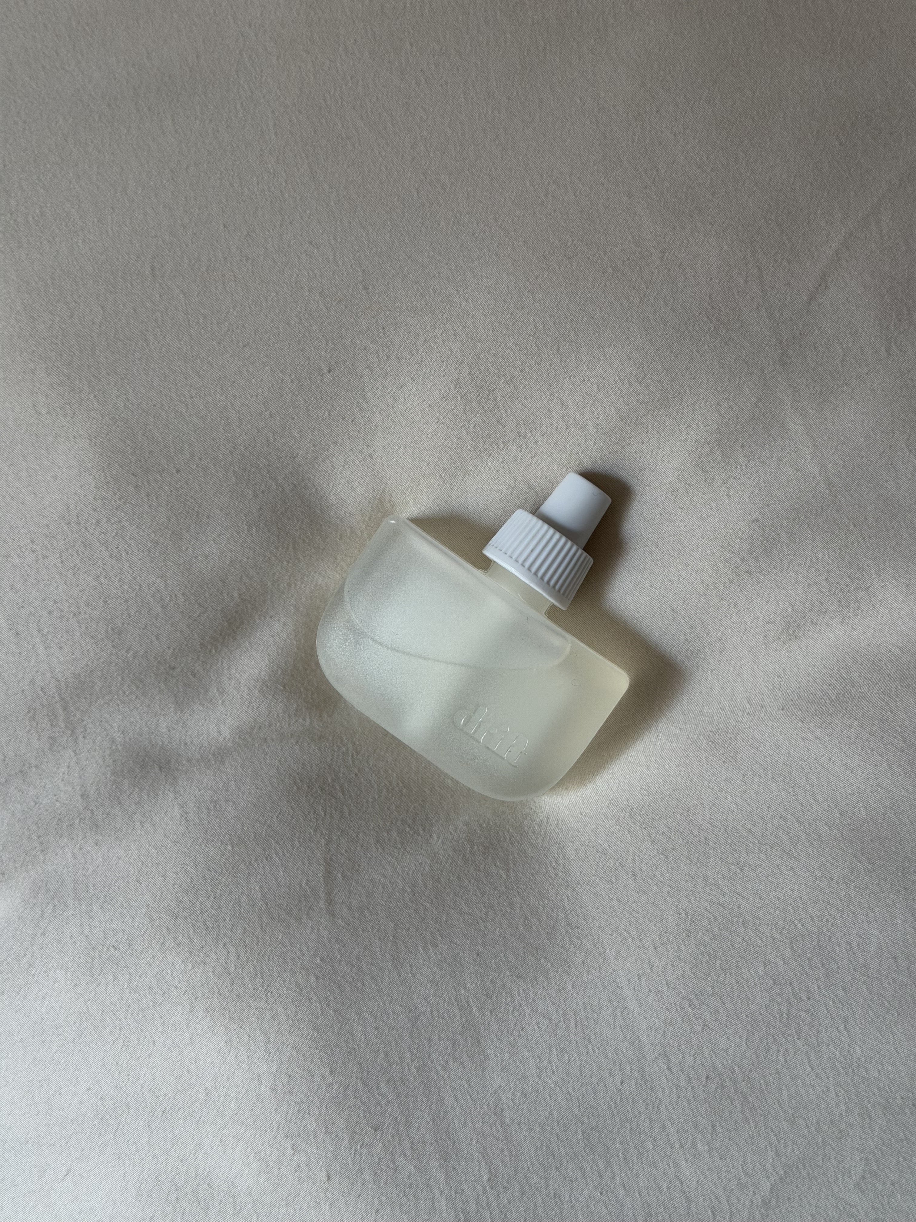 The Drift Home Scent Diffuser in Rest & Relax on a bed.