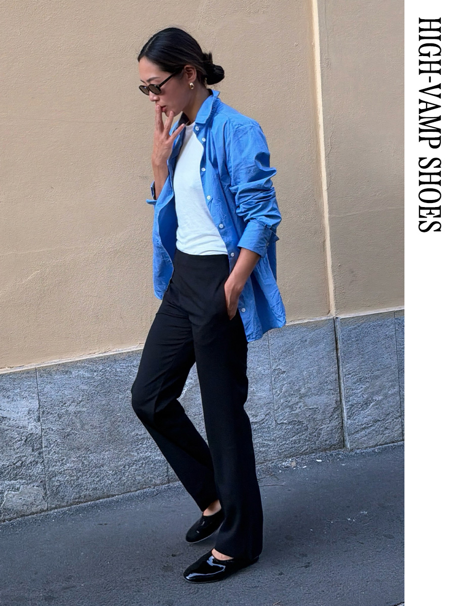 Aimee Song wearing a blue button-down, white tee, black pants, and high-vamp ballet flats